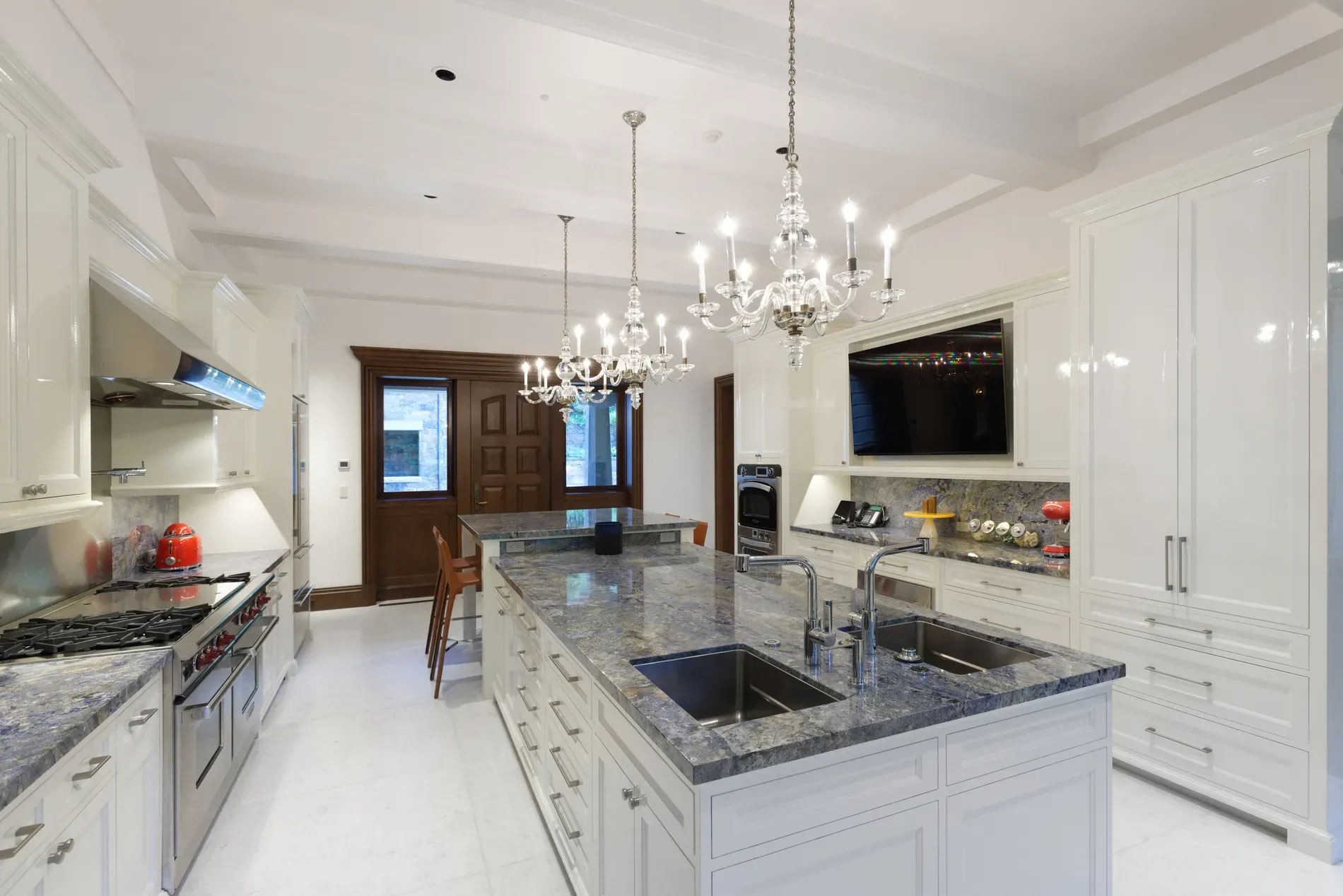Here's the kitchen—white cabinets, stormy blue stone. Feels crisp, not sterile.