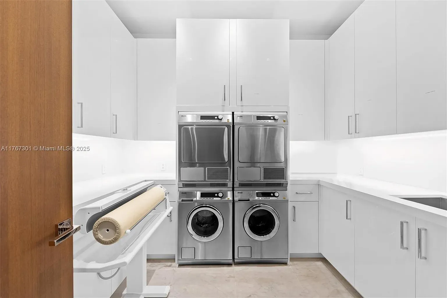Laundry room is glossy and bright. Zero excuses left for piles.