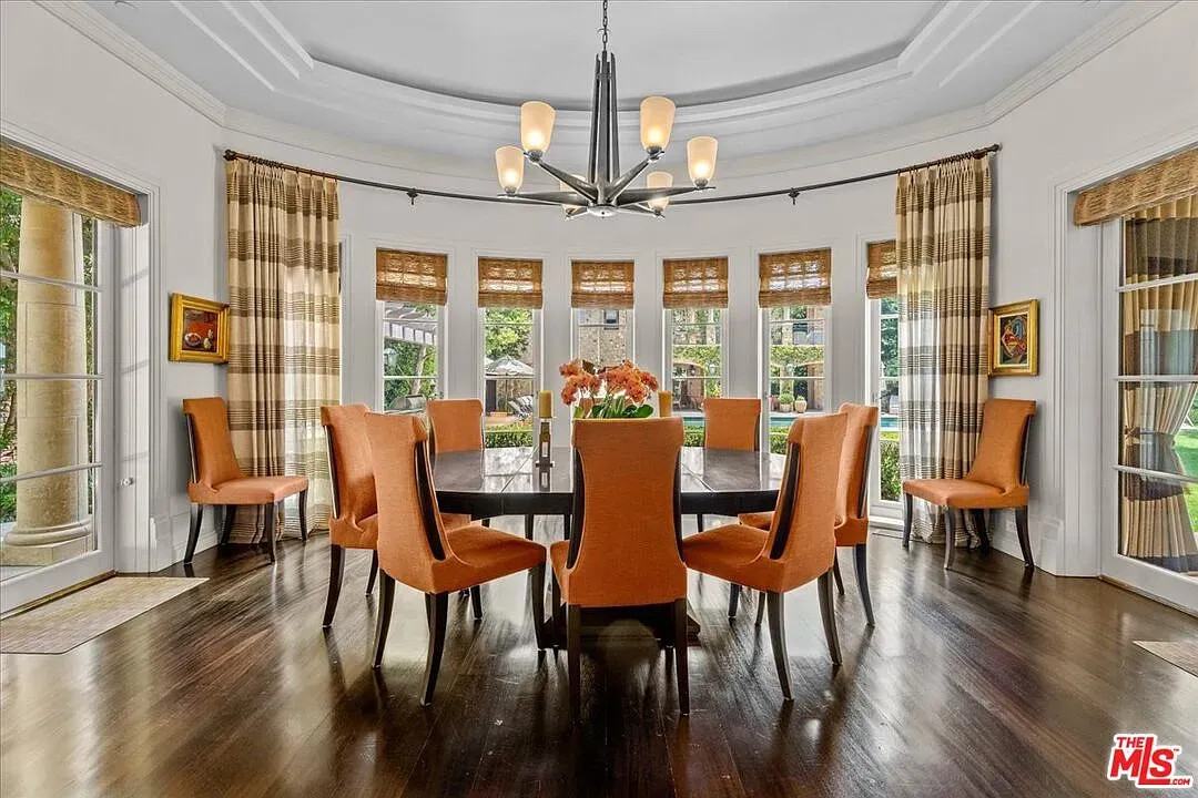 Round dining room with a massive table. Family reunion headquarters.