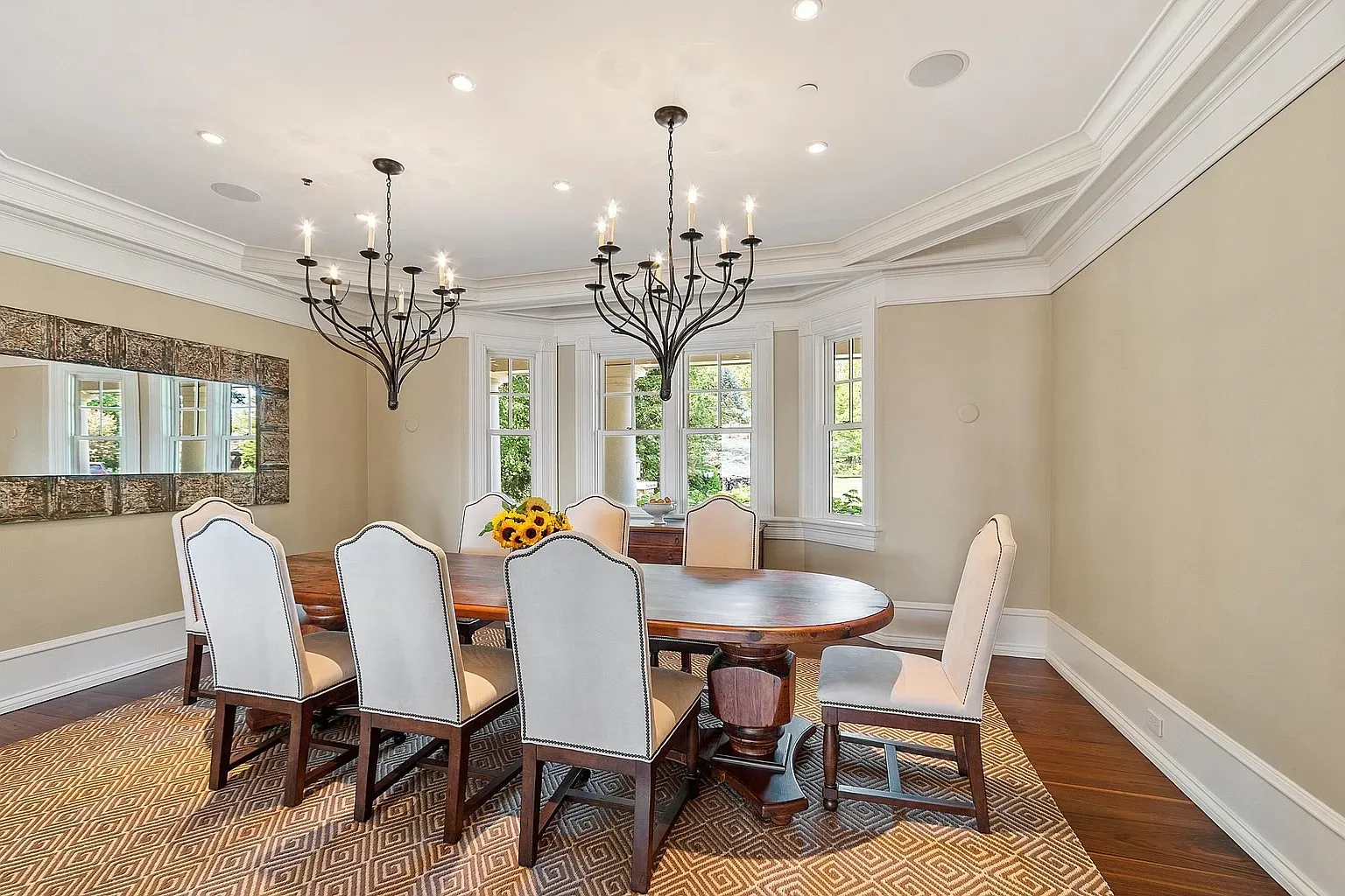 Oval table, classic chairs, feels holiday dinners actually happen here.