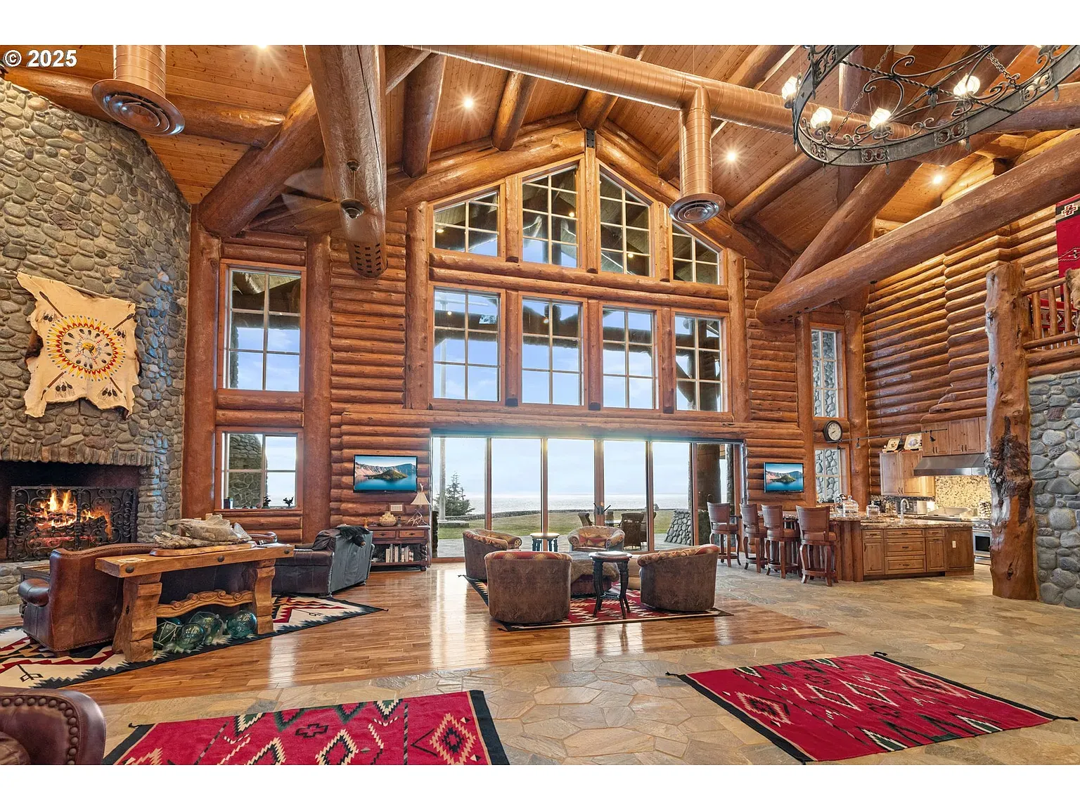 Great room goes full lodge mode. Beams crisscrossing a giant X game.