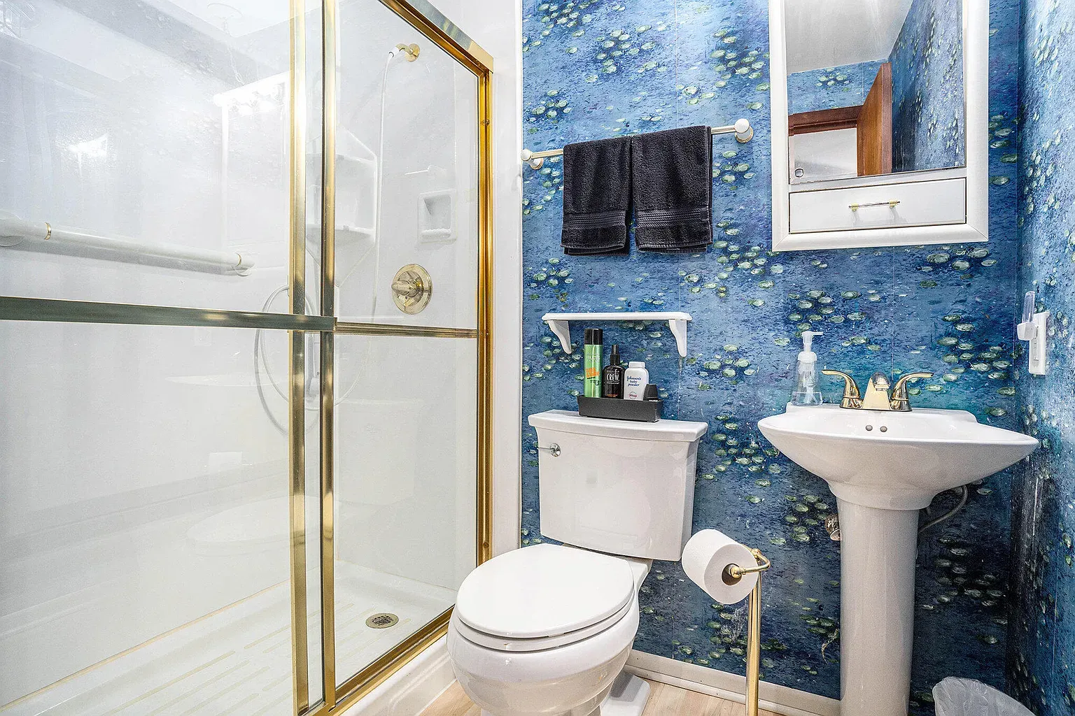 Water-print wallpaper steals the show. Spa vibes without trying too hard.