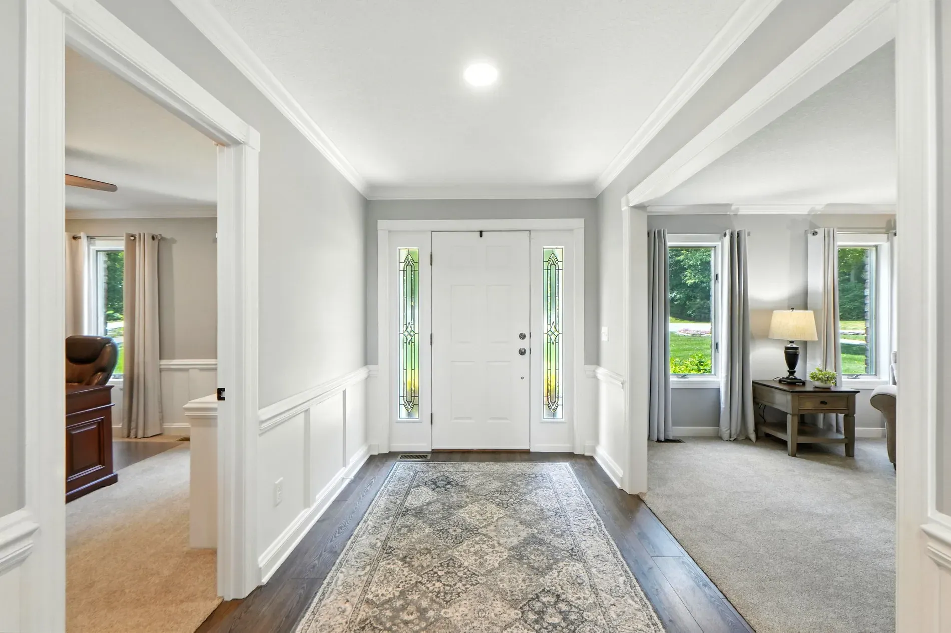 Here’s the entry — bright, soft grays, nice wainscoting. Feels calm.