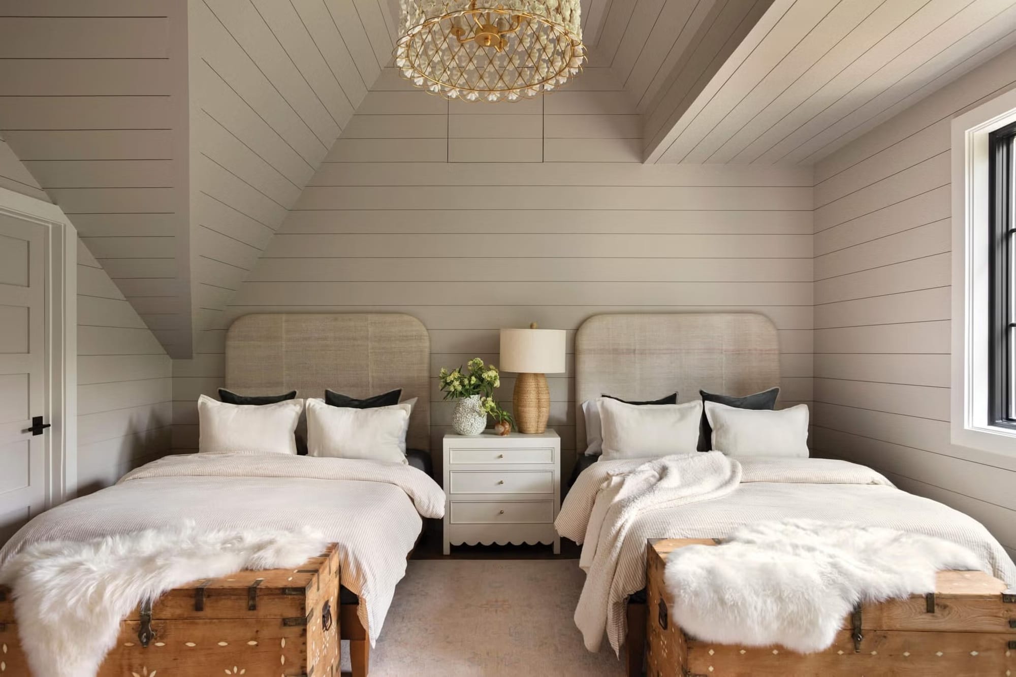 Twin beds with gray shiplap, sleepover energy but grown-up calm.
