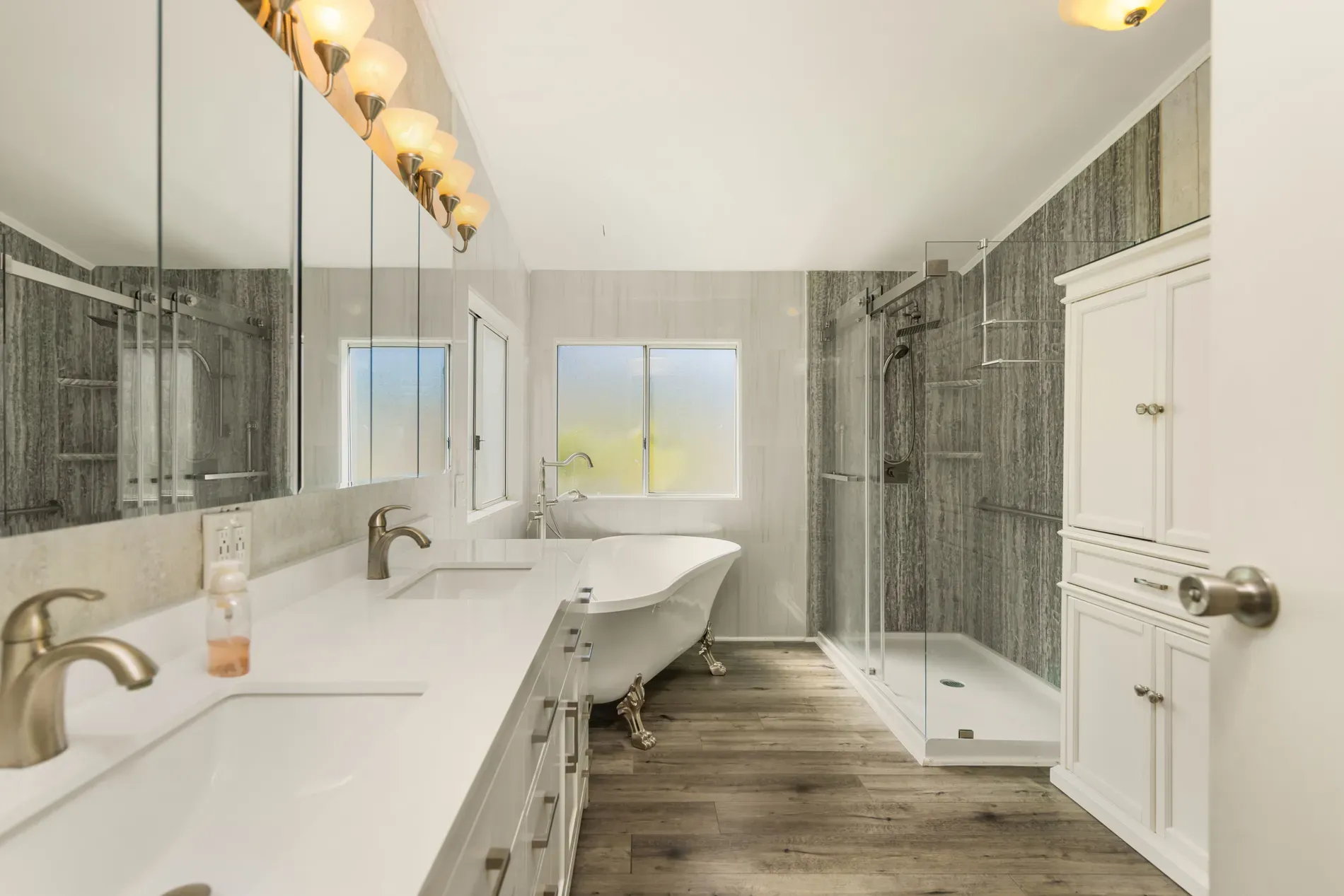 Bright bathroom, frosted window, gray textured tile. Looks spa-y without trying.