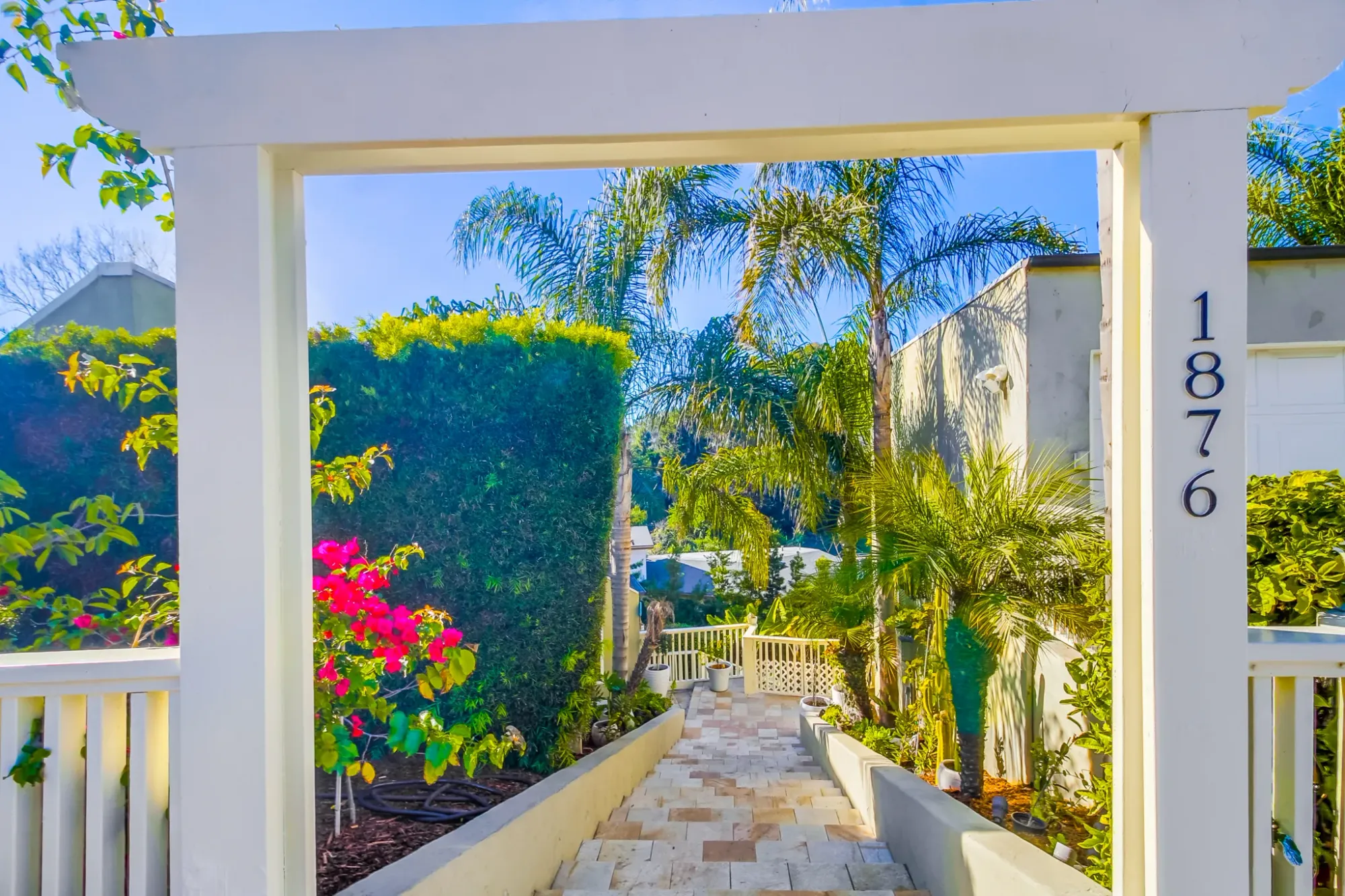 White arch with 1876. Kinda feels a portal to the house.