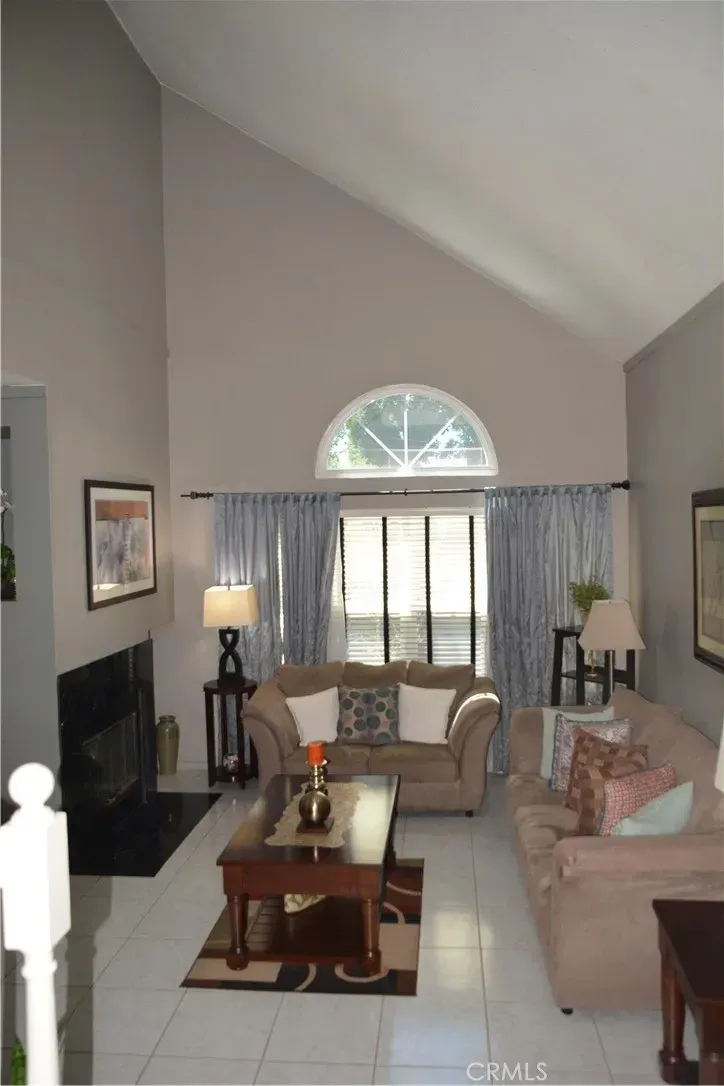 Living room goes taupe with a high ceiling. Modern/classic mashup. I think it works?