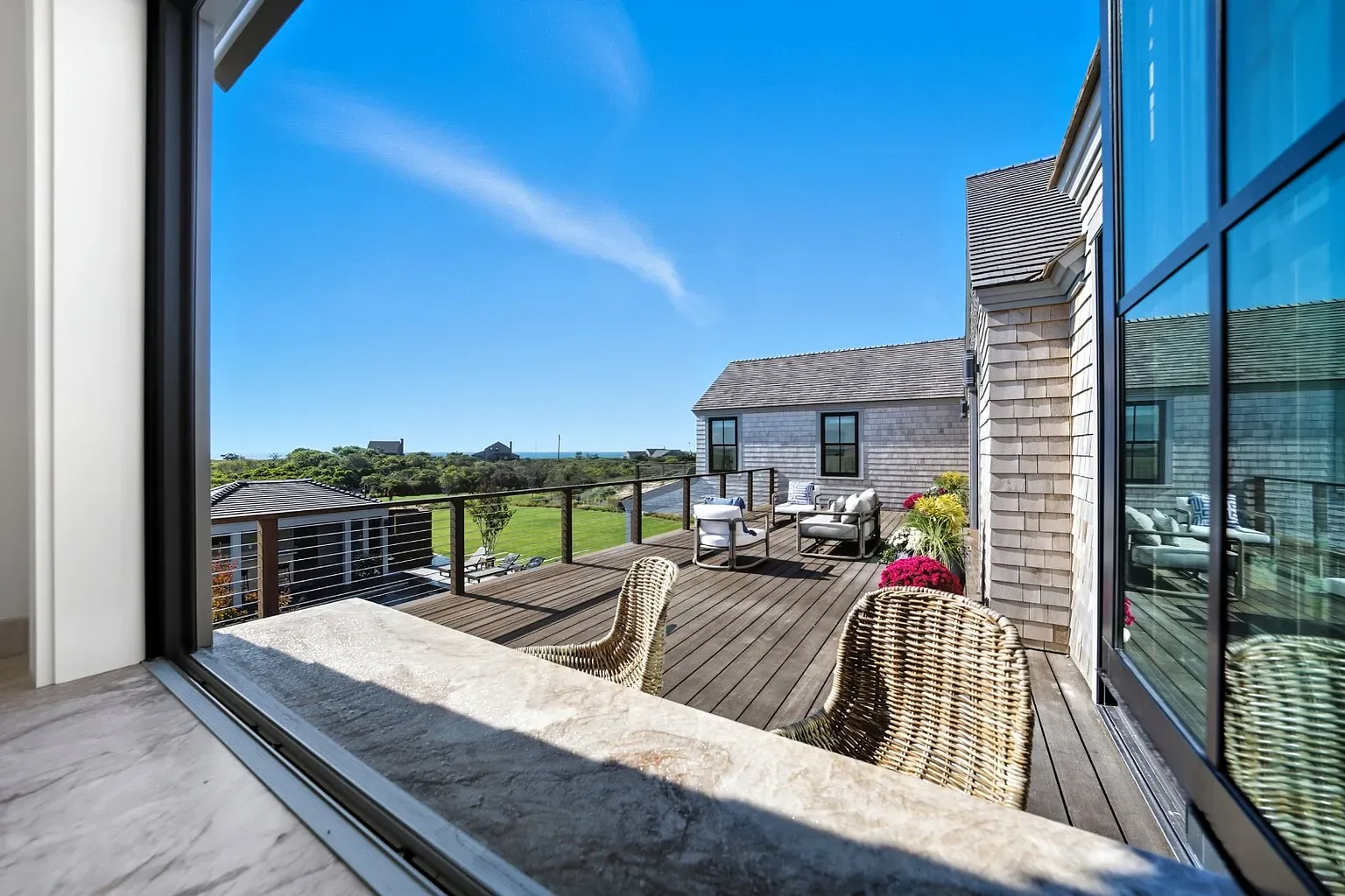 Big sliders out to a wide deck. Wood looks freshly oiled.