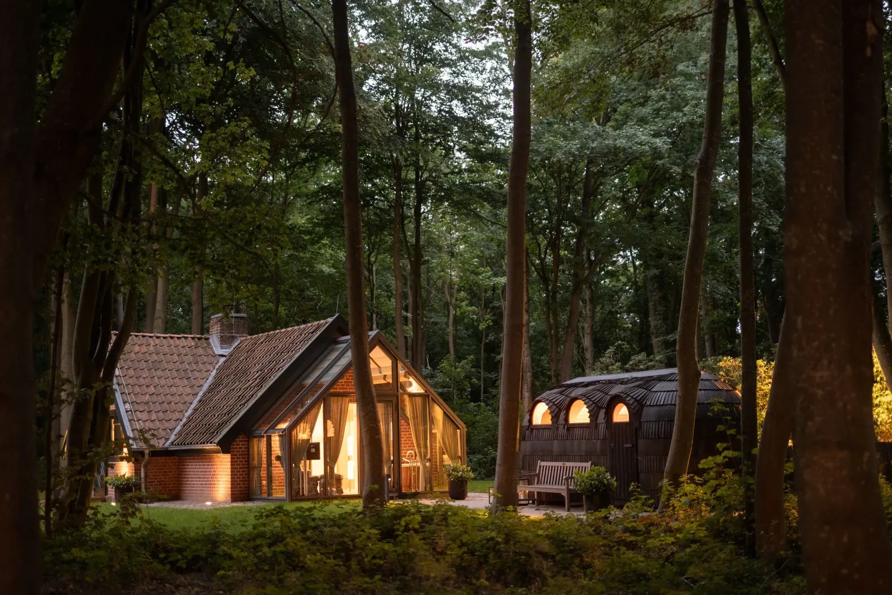 Forest cabin moment—timber, steep gable, little terra-cotta roof situation.