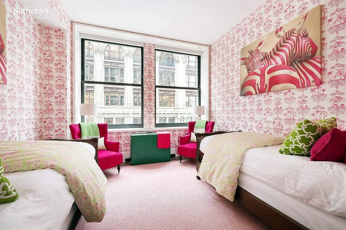 Two twin beds against pink florals. Adorable guest room or kids’ sleepover HQ.