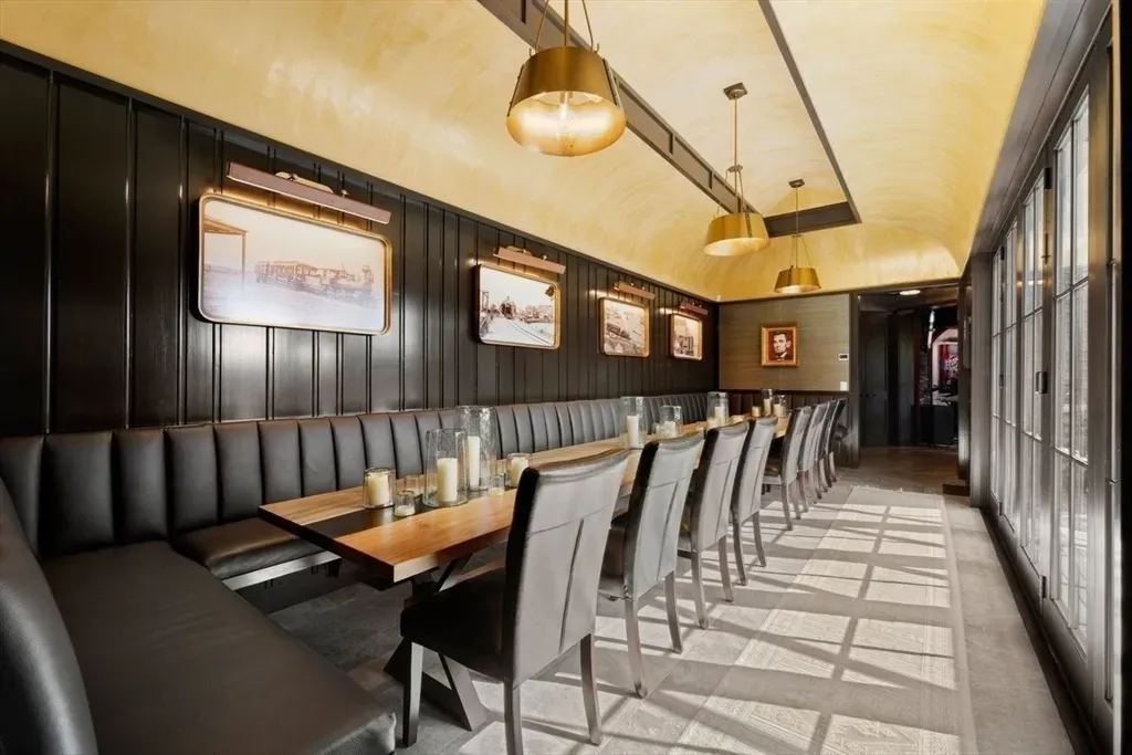 Curved gold ceiling over dark paneling. Kinda moody, kinda glam dinner spot.
