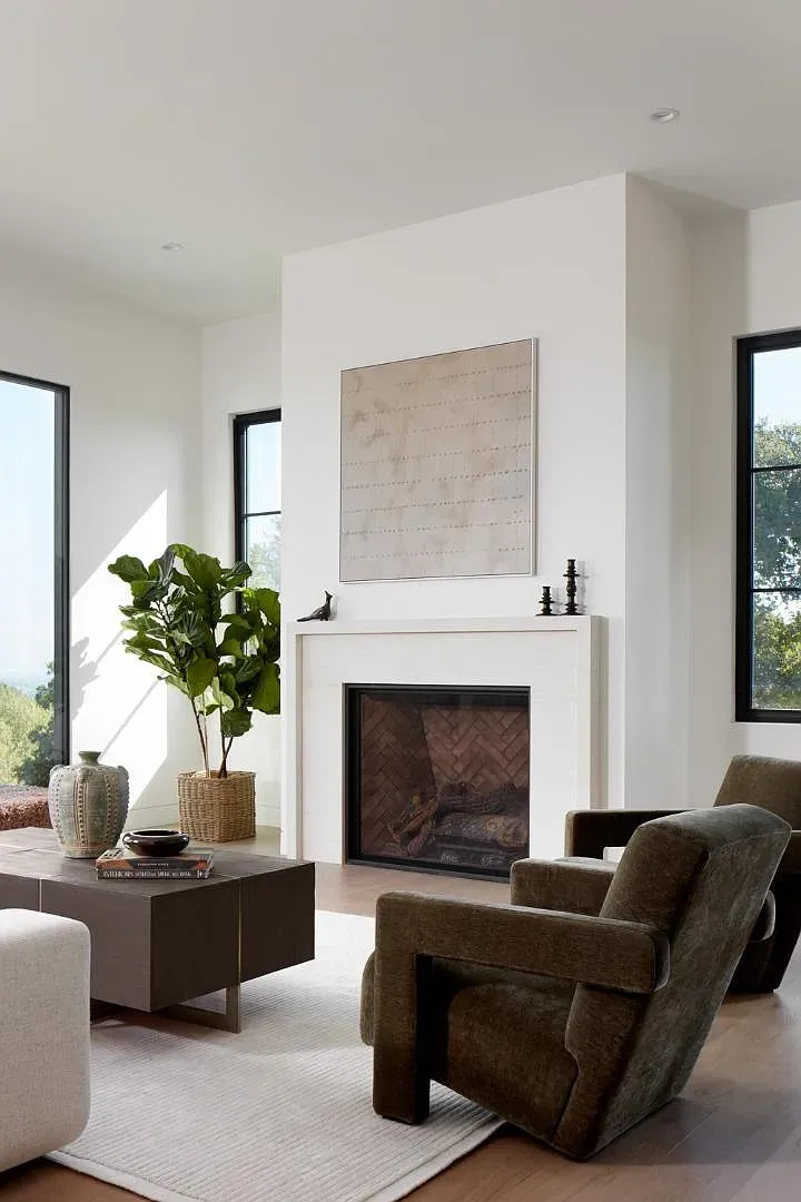 Minimal living room. the herringbone fireplace surround steals the show.