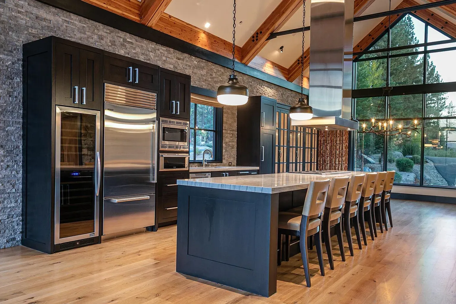 Second kitchen angle. vaulted beams, sleek cabinets, big island begging for pancake duty.