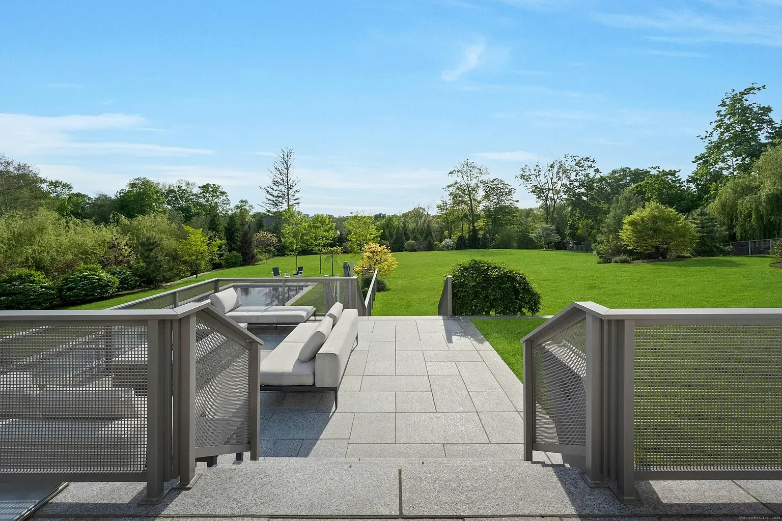 Big stone patio, clean lines, metal railings. Anyone else want glass here?