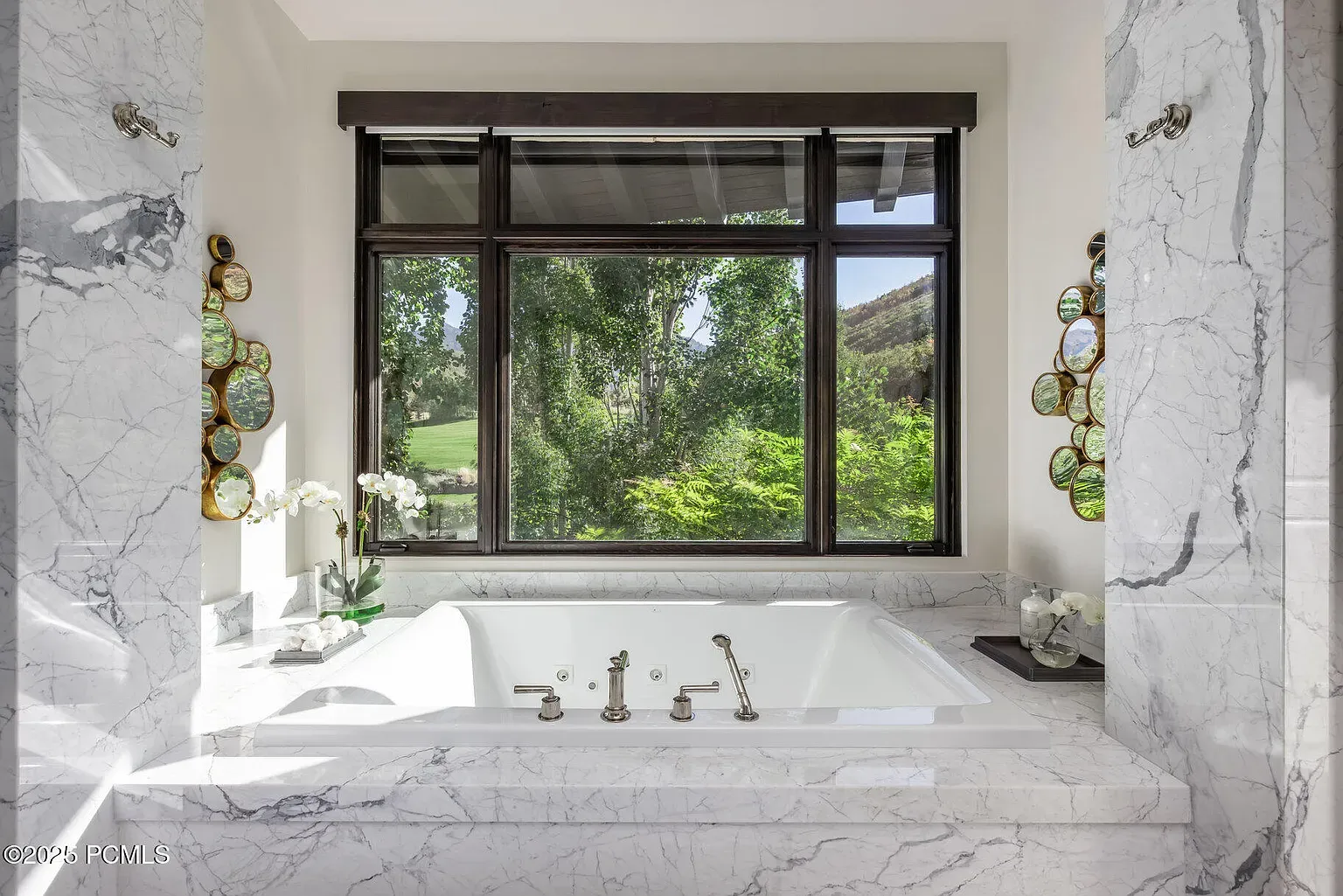 Sunken tub in marble everything. Views doing spa-level therapy for free.