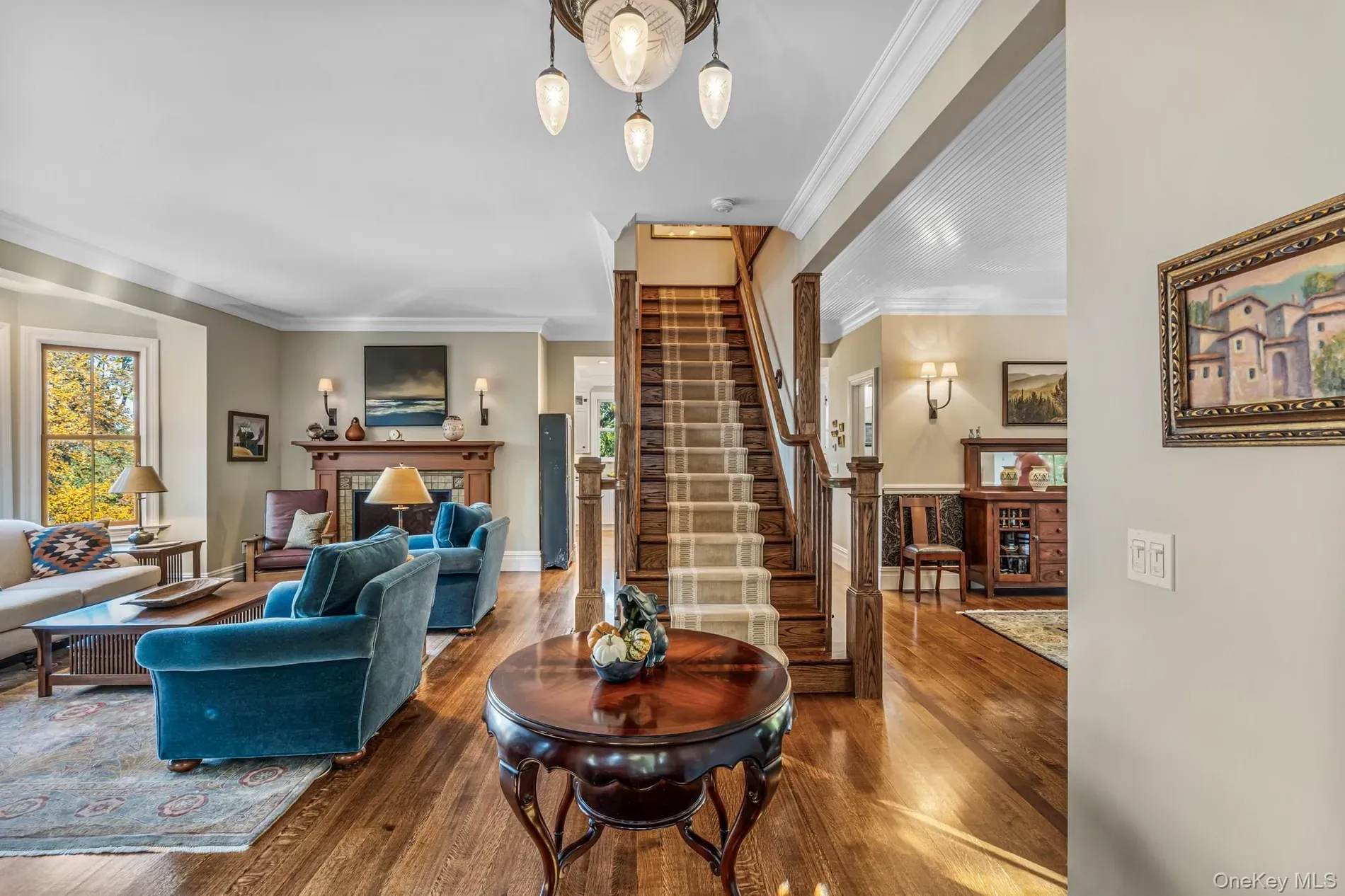 Teal sofas popping against honey floors. surprisingly cozy and bright.
