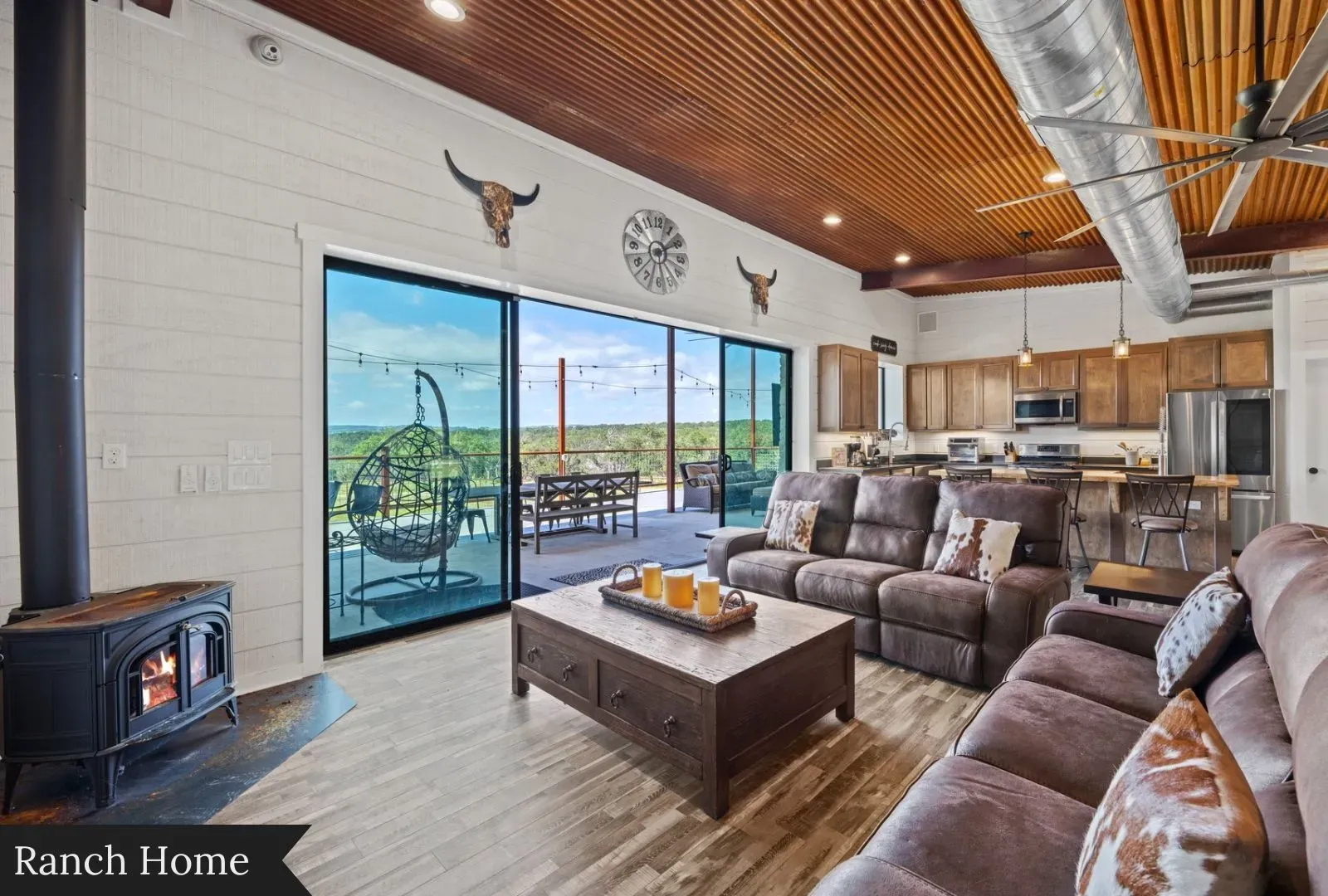 Here’s the living room — leather sectional, chunky coffee table, solid movie-night energy.
