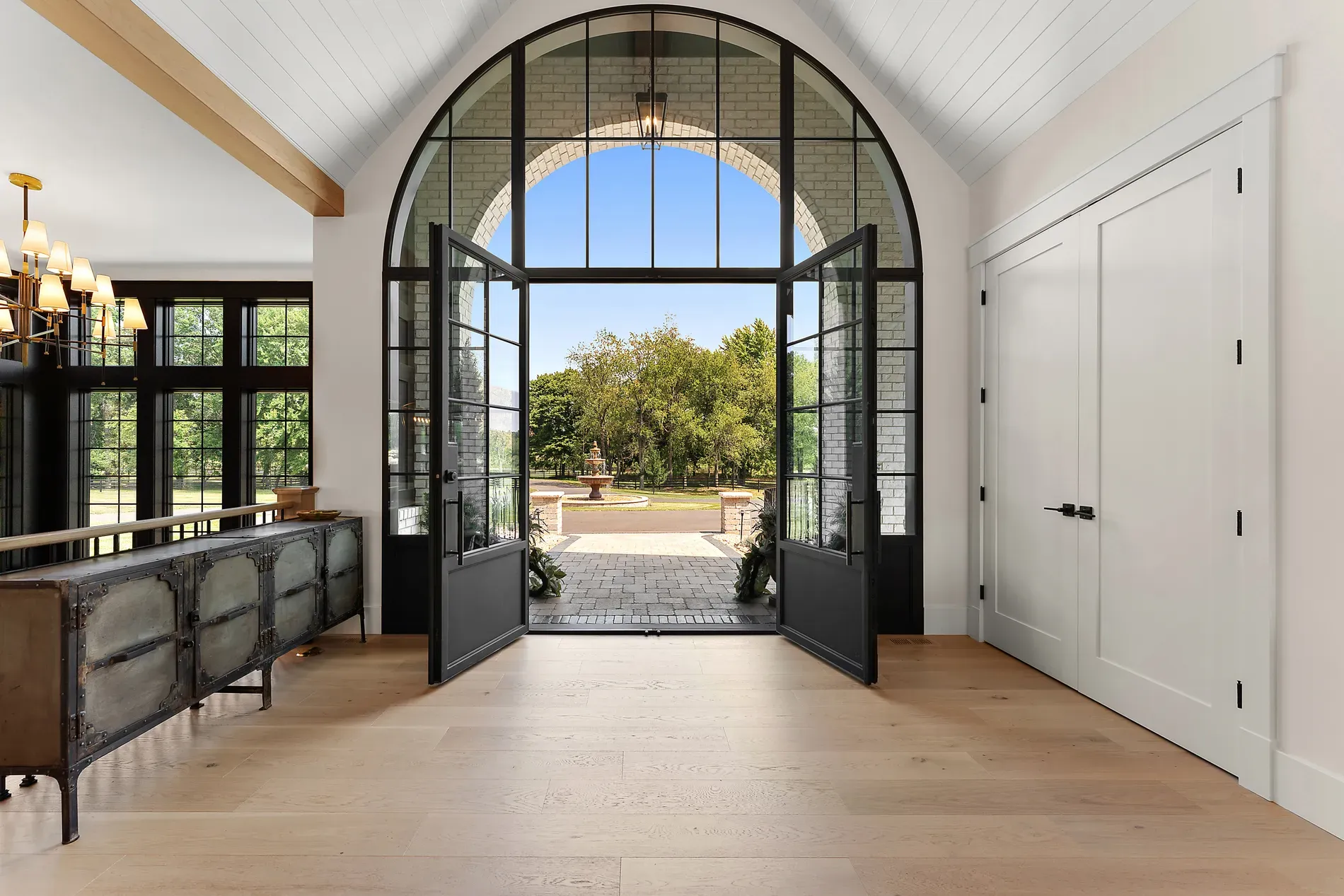 Grand arches at the entry. Black steel doors, glass everywhere, hello sunshine.