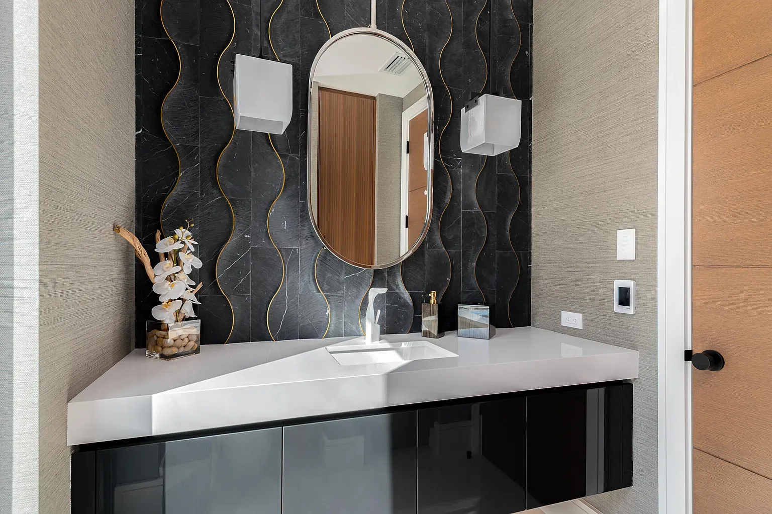 Black marble with gold veins goes full glam. Vanity's floating it levitates.