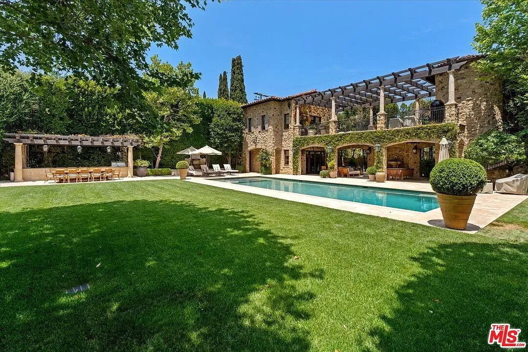 Stone villa, big lawn, pool ready. This is the postcard shot.