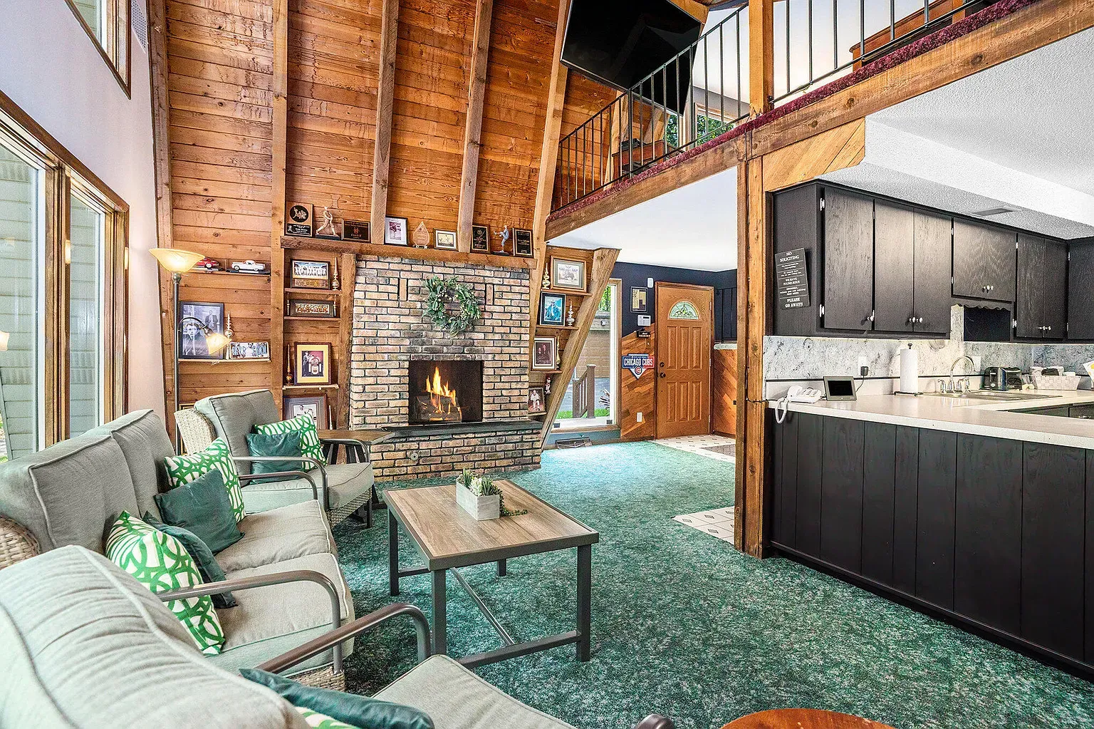 Brick fireplace anchors it. Beams overhead make everything feel bigger.