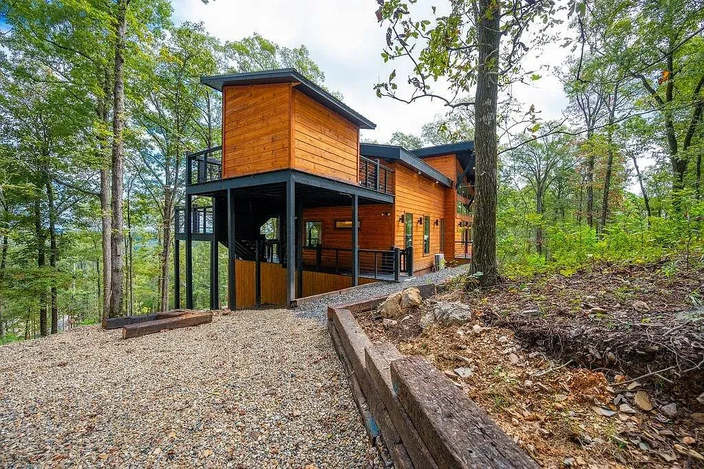 Same warm wood outside, tucked in the trees. Black metal accents look sharp.