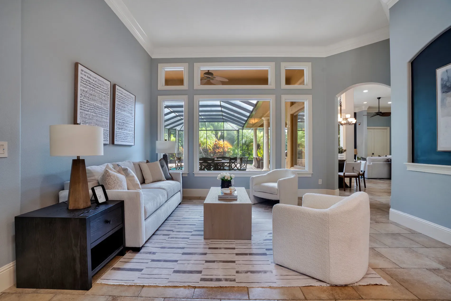 Living room goes soft blue and bright. Calm, breezy, lots of windows.