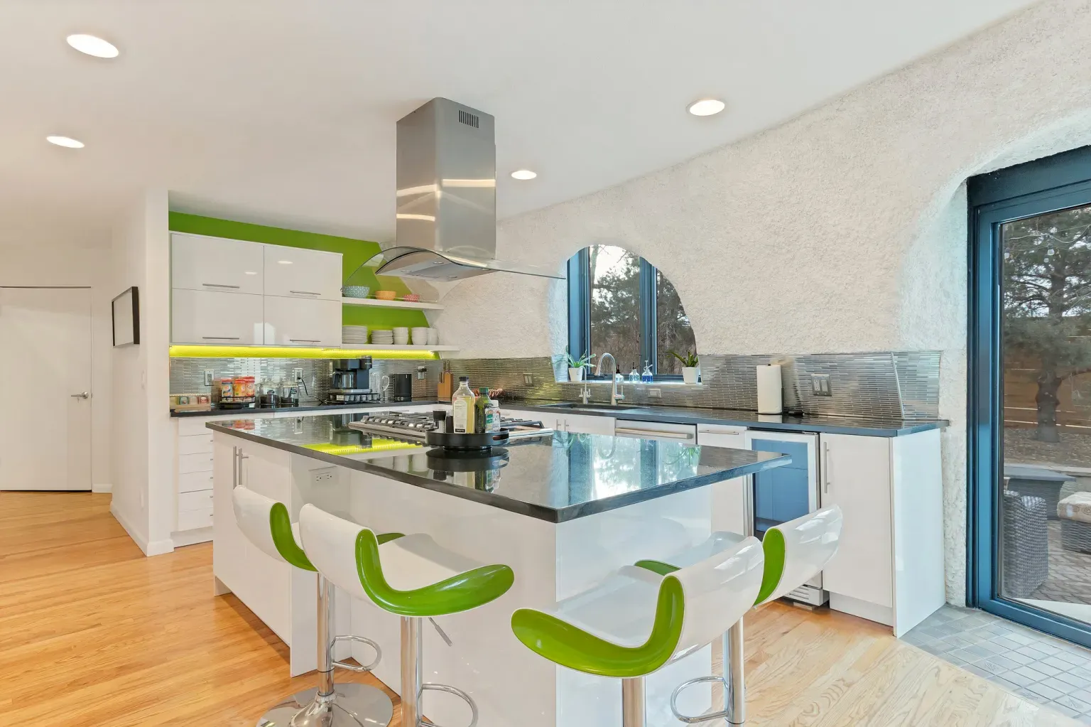 Kitchen flexes an arched window and bold cabinets. Tons of light.