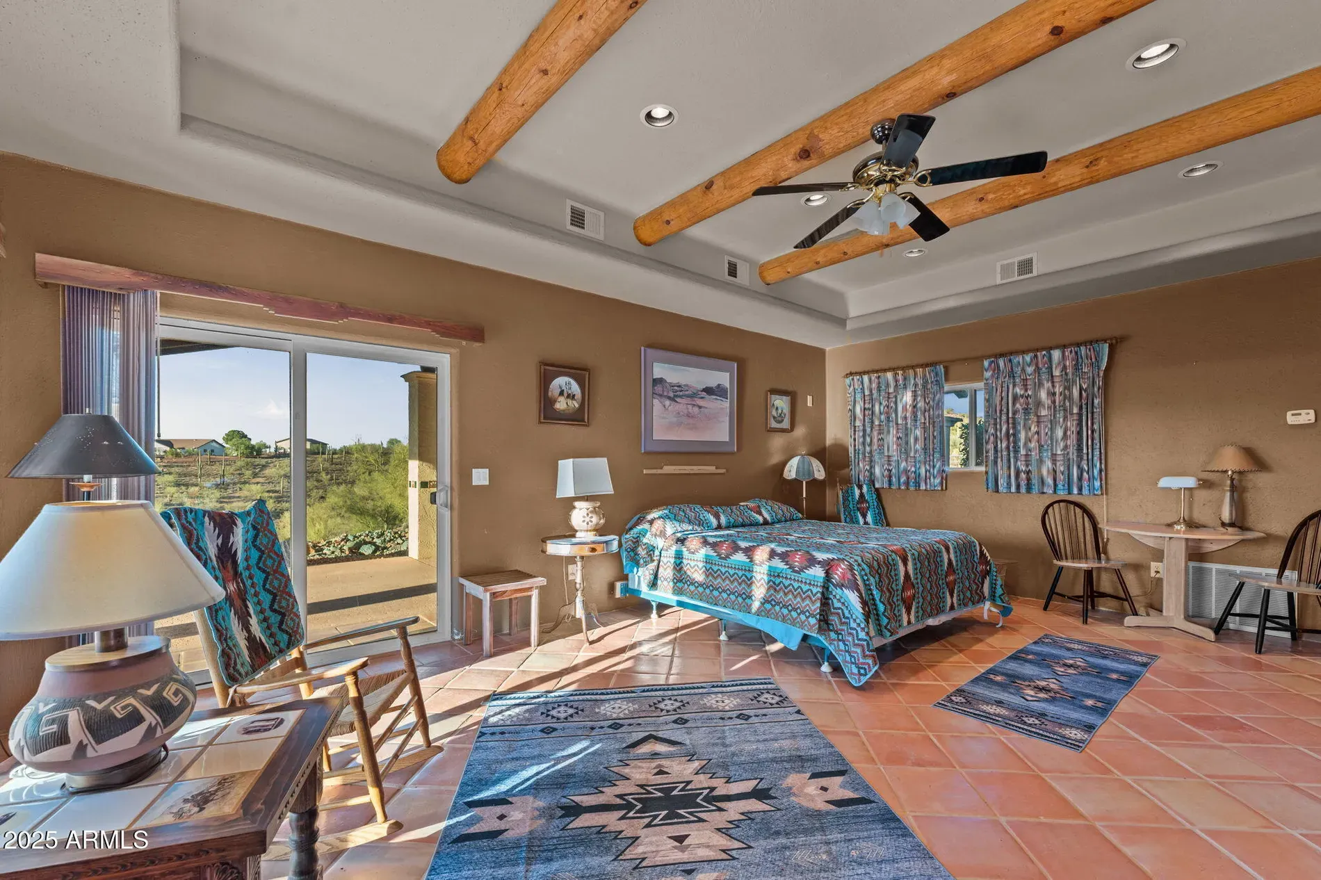 Bedroom brings the beams and tile. Warm tan walls keep it calm.