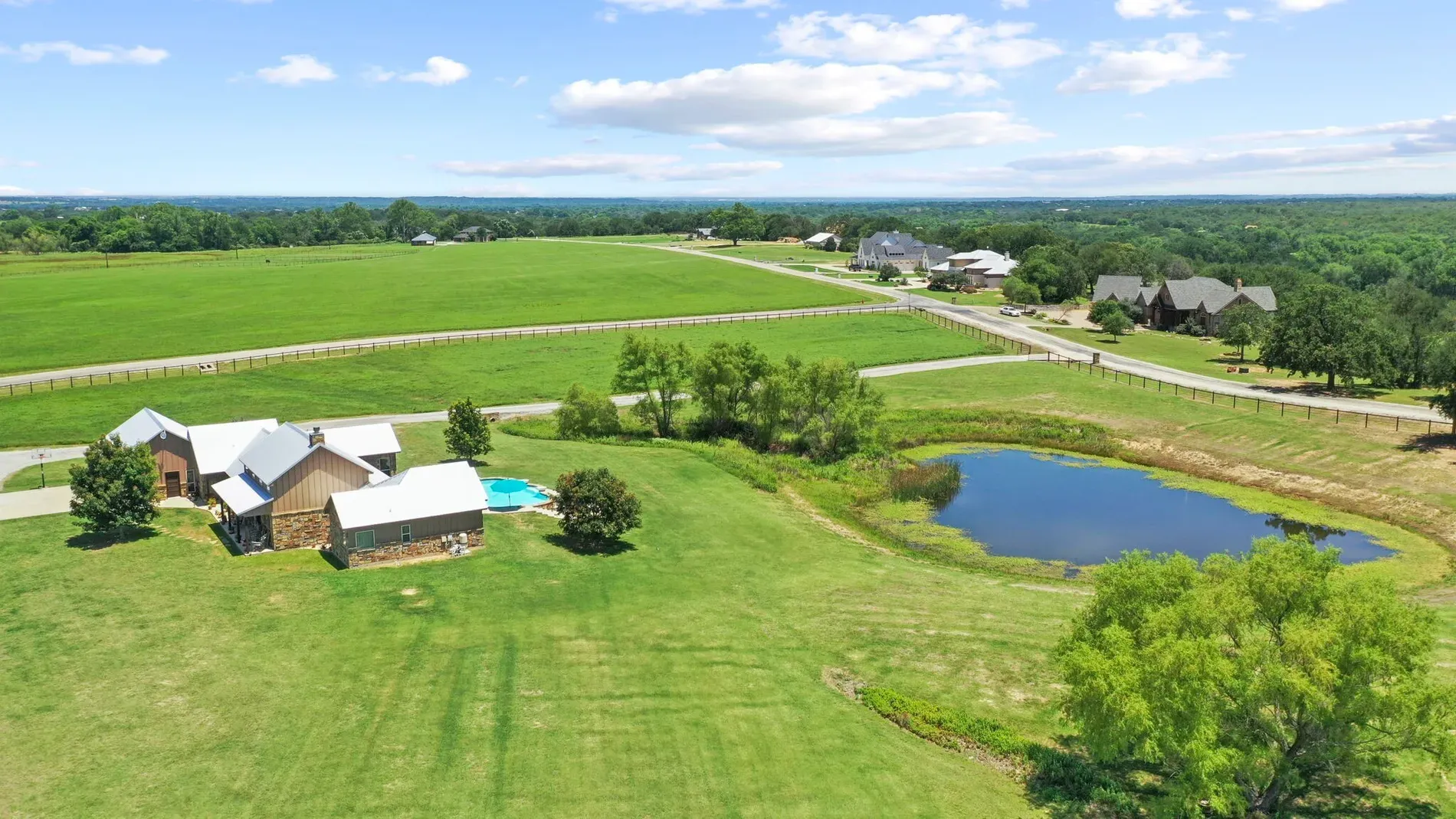 Wide-open fields around a modern rustic house. Honestly, dream Sunday views.