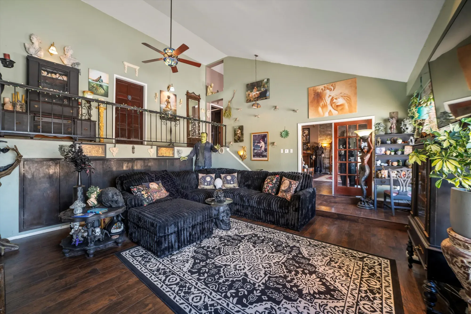 Sage walls, dark wood, vintage-meets-modern. I’d hang out here for hours.