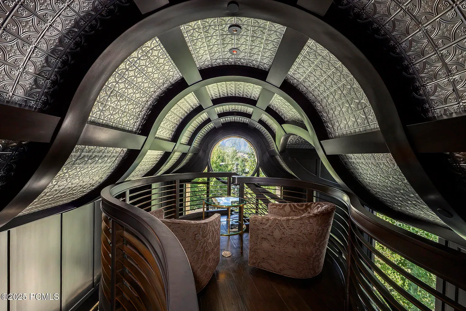 Loft goes full sci-fi. Curves, metallics—anyone know why the shimmer ceiling?