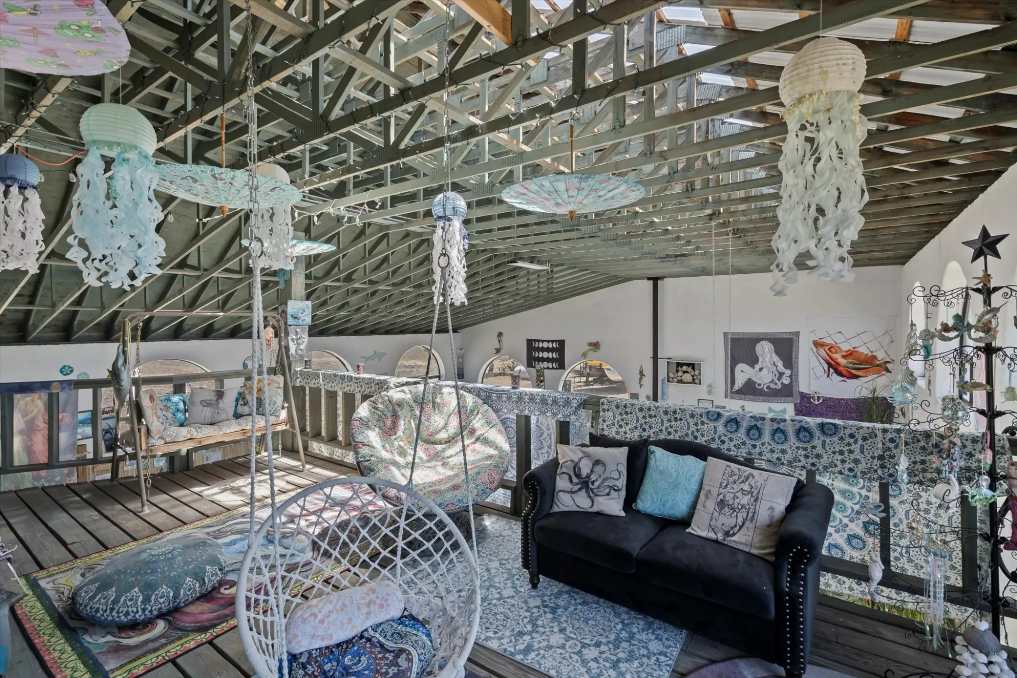 Loft with turquoise beams and big windows. Feels easy and artsy.