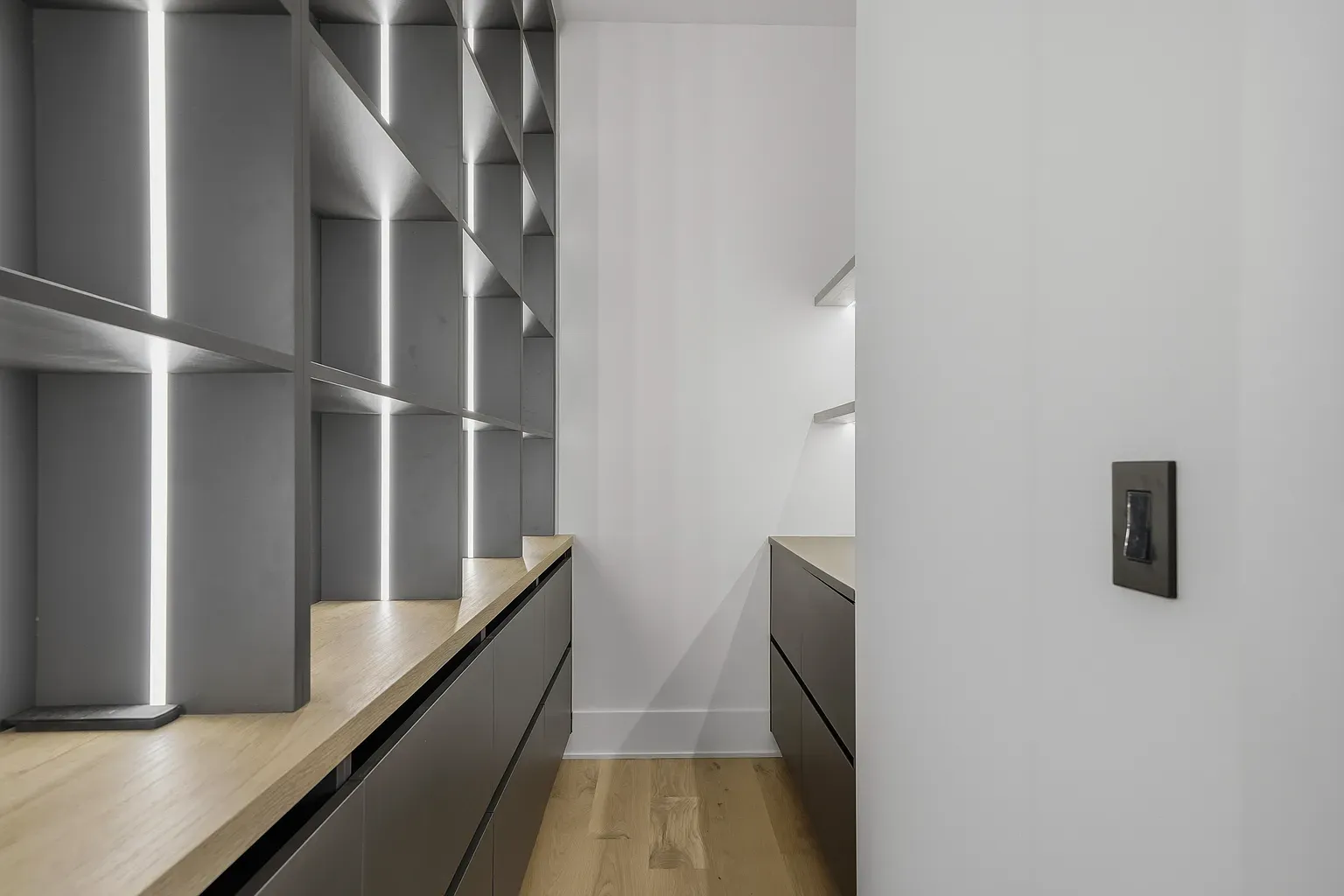 Utility room is clean and simple. Gray cabinets, wood counters, no clutter.