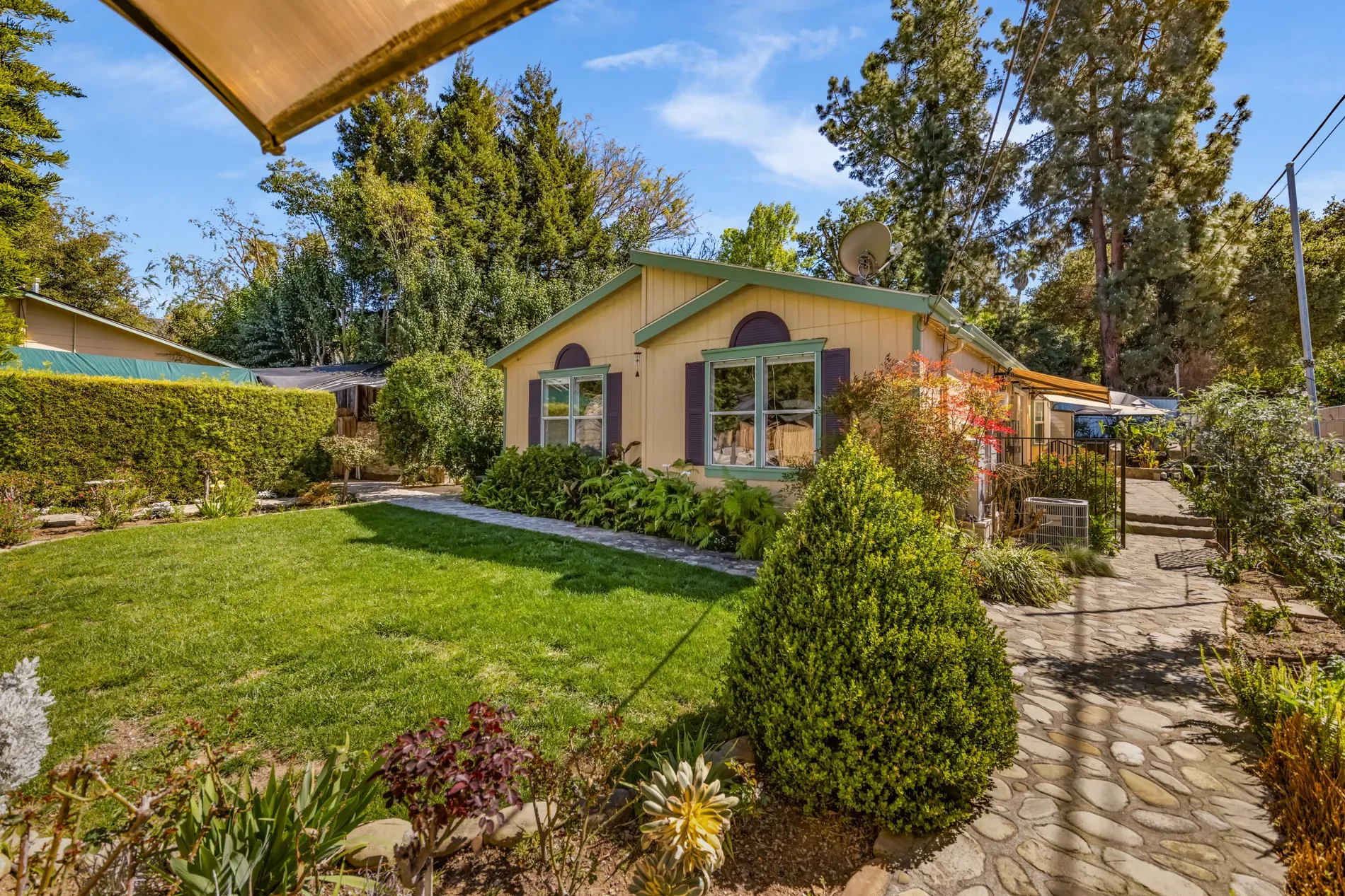 Pastel pink cottage with mint roof and purple trim. Kinda storybook.