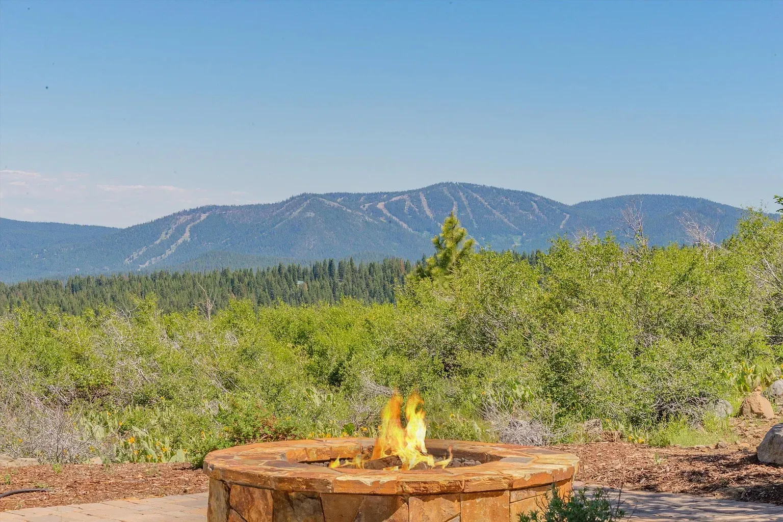 Fire pit tucked into the rocks. I’d be out here nightly.