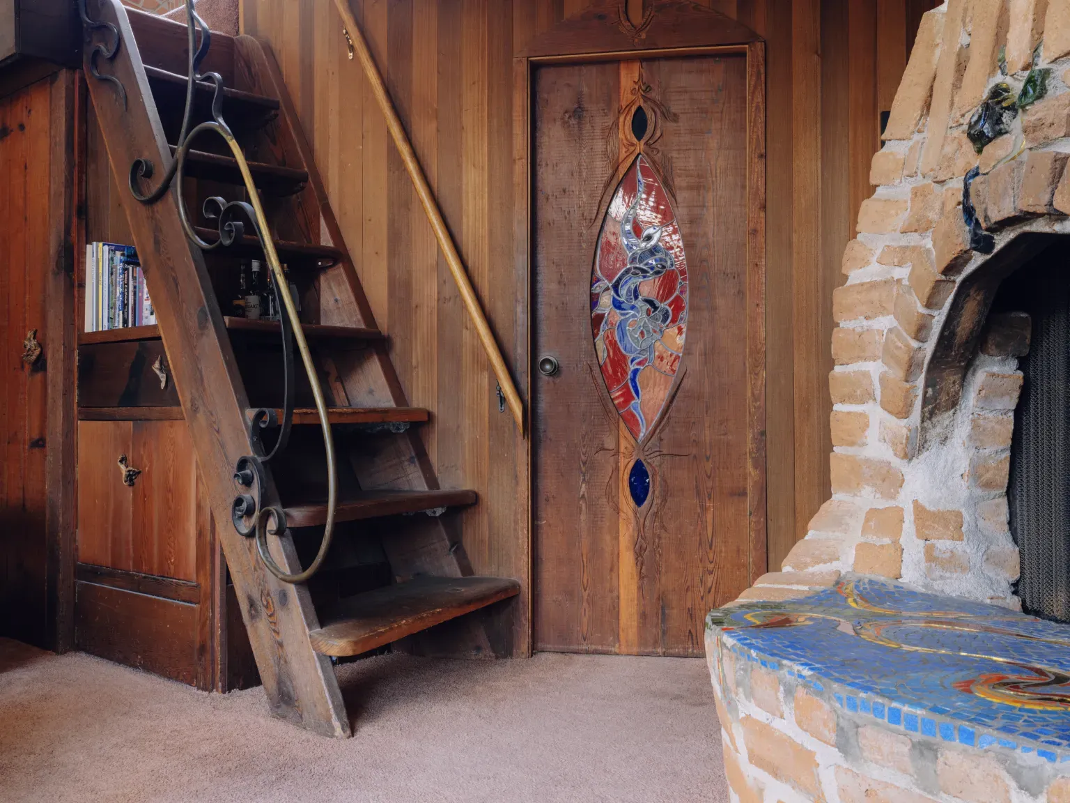 Wood paneling for days, and that stair sneaks up the corner.