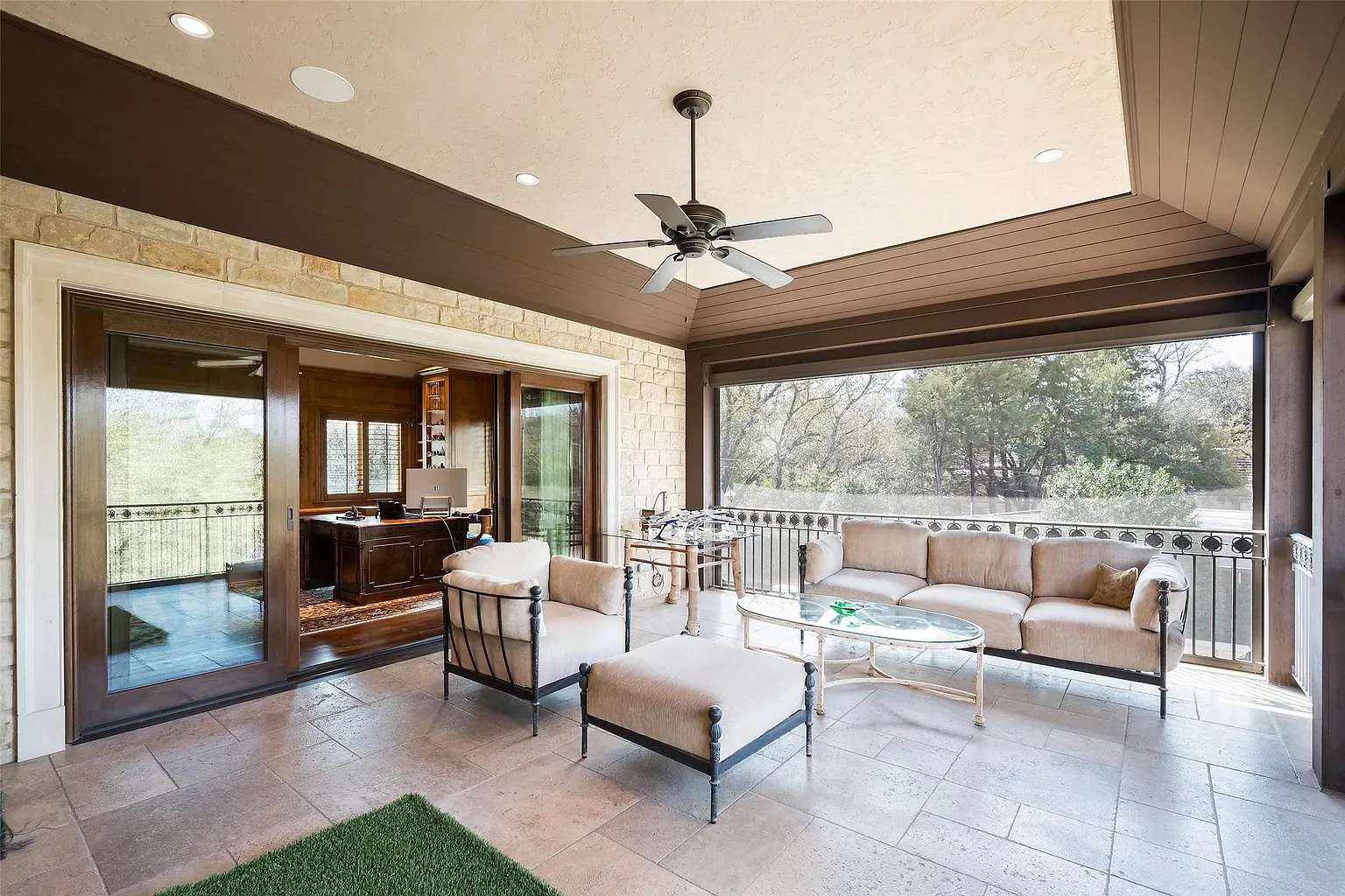 Sunroom time. earthy tones, comfy seating, ceiling details doing subtle flex.