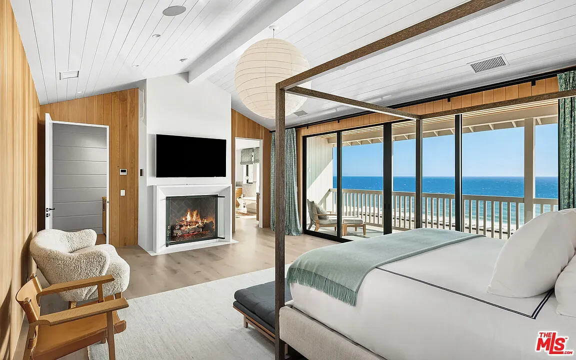 Bedroom opens straight to the sea. Those sliders make mornings pretty unfair.