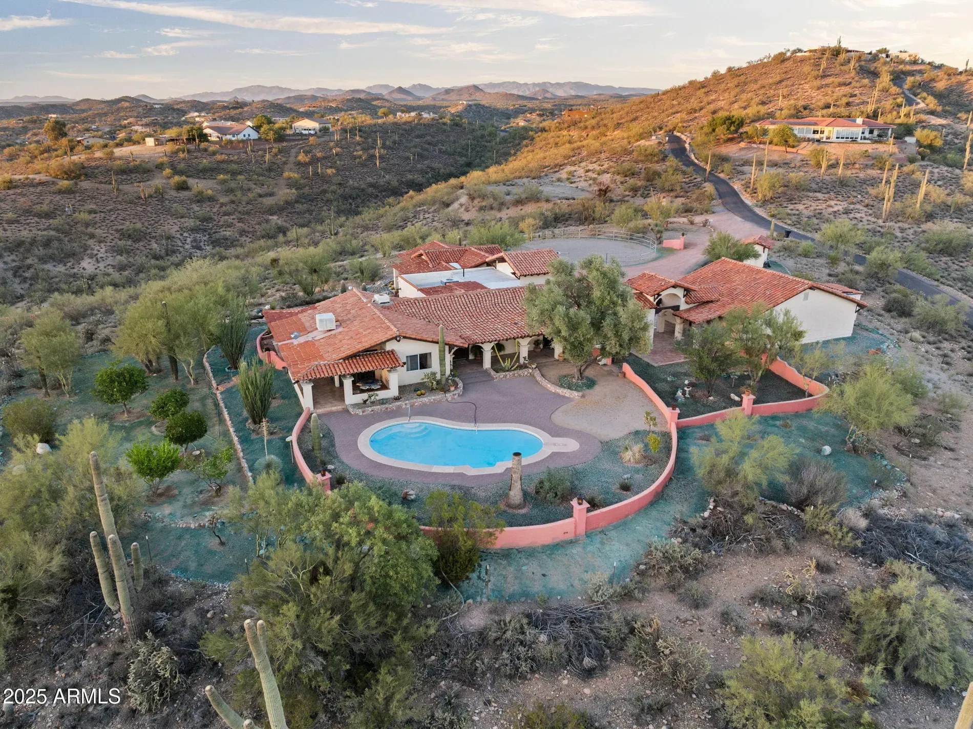 Saguaro guardians at the door. Classic adobe and roof tiles.
