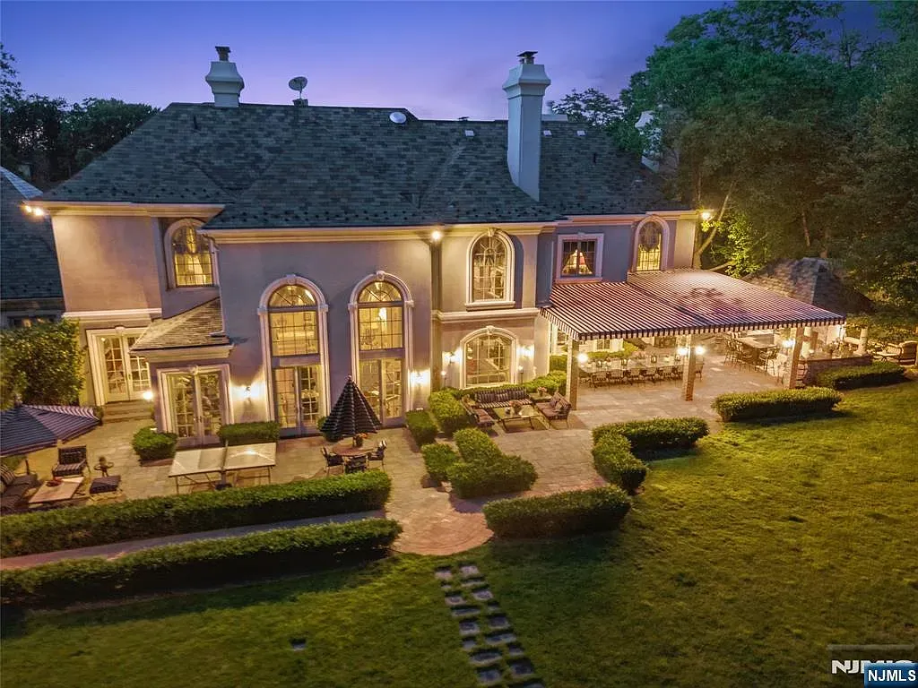Back outside—arched windows glowing at dusk. Beige exterior looks soft.