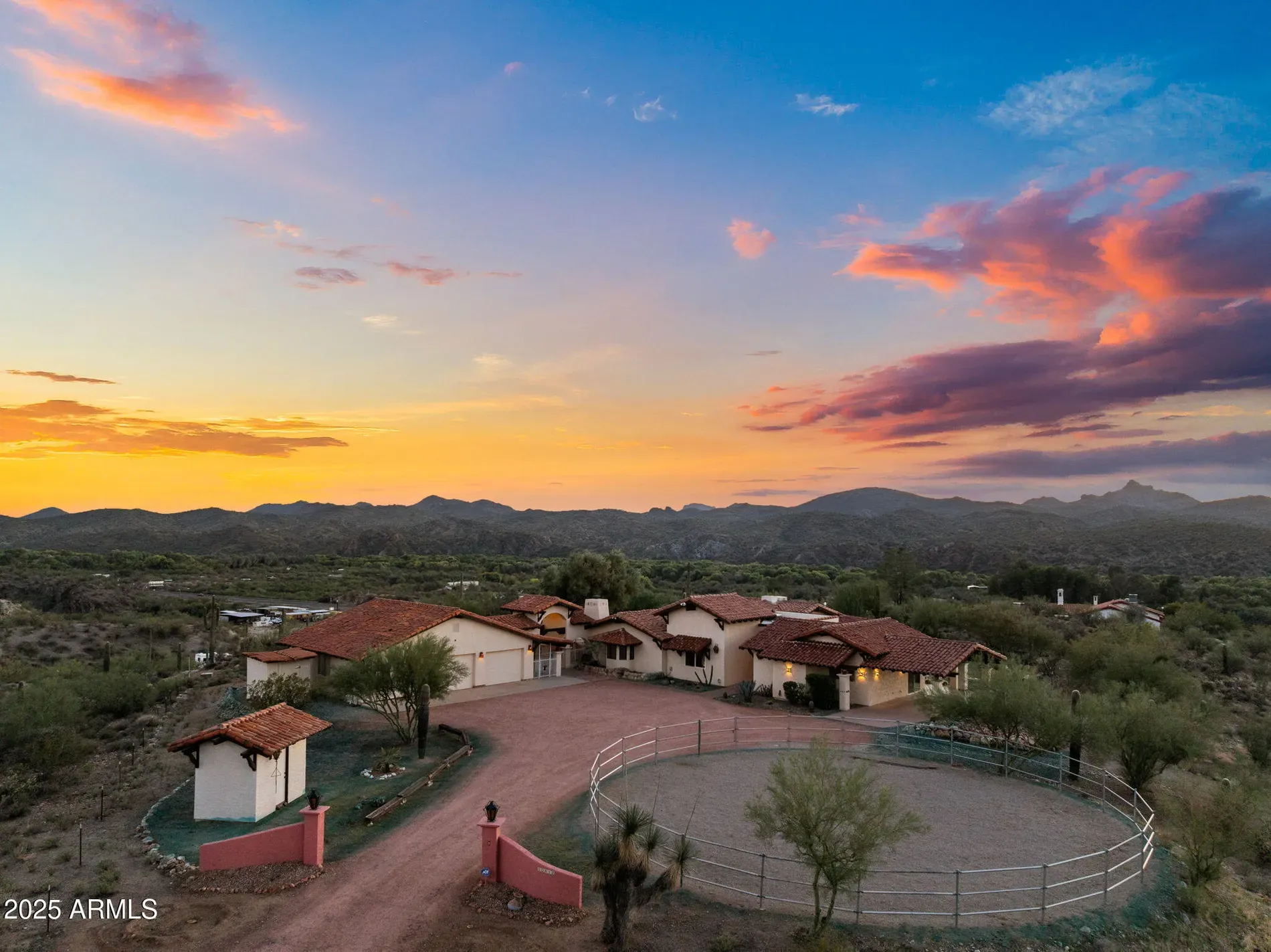 Sunset making the stucco glow. Spanish vibes, wide sky.