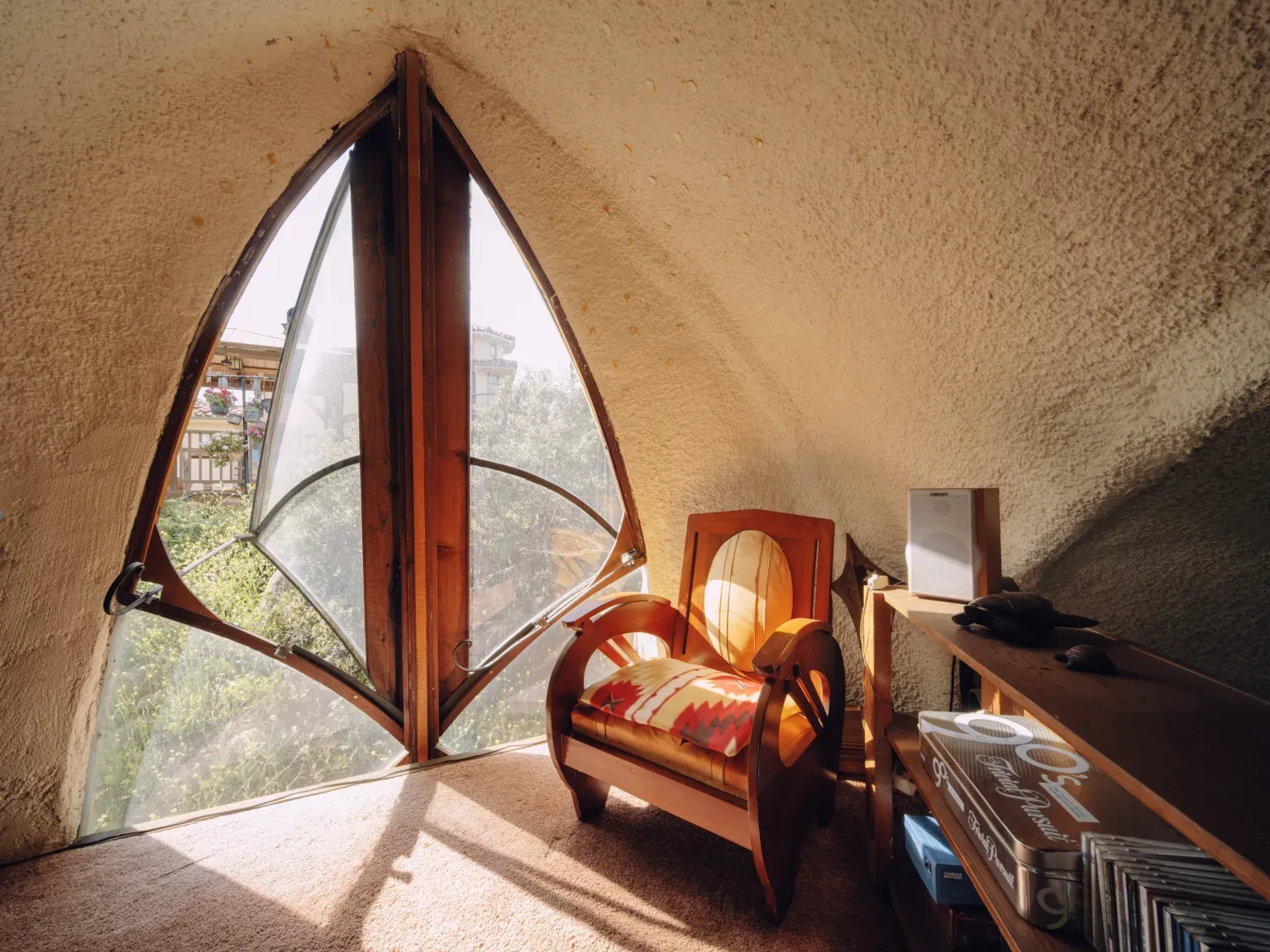Center hearth built into the curves. Earthy plaster everywhere.