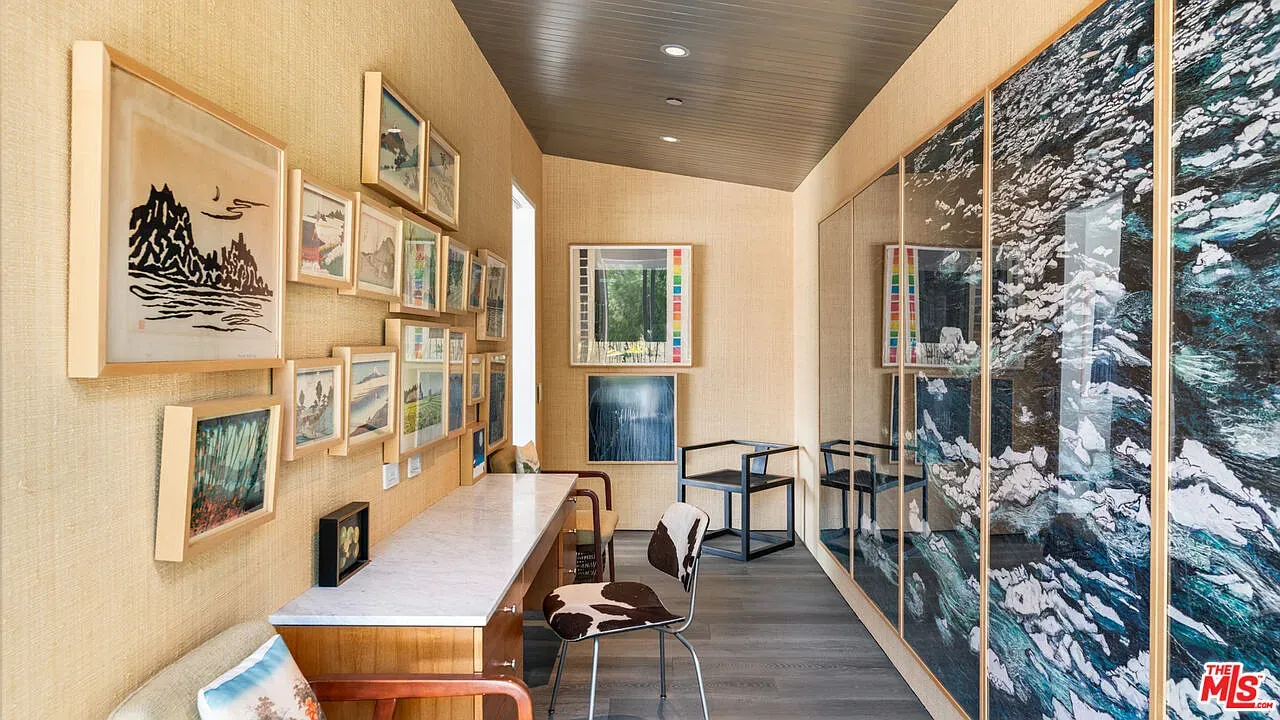 Soft beige walls and a tidy gallery wall. Kinda museum vibes, cozy.