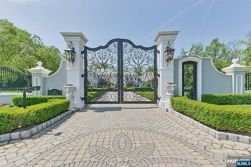 Here's the entrance—iron gate on white pillars. Lanterns make it feel grand.