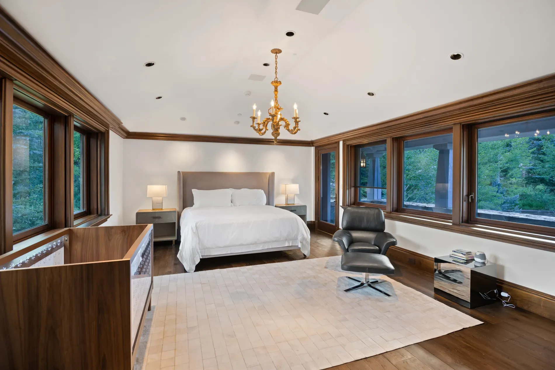 Second bedroom leans luxe—white linens, heavy wood. Cozy, maybe a bit serious.
