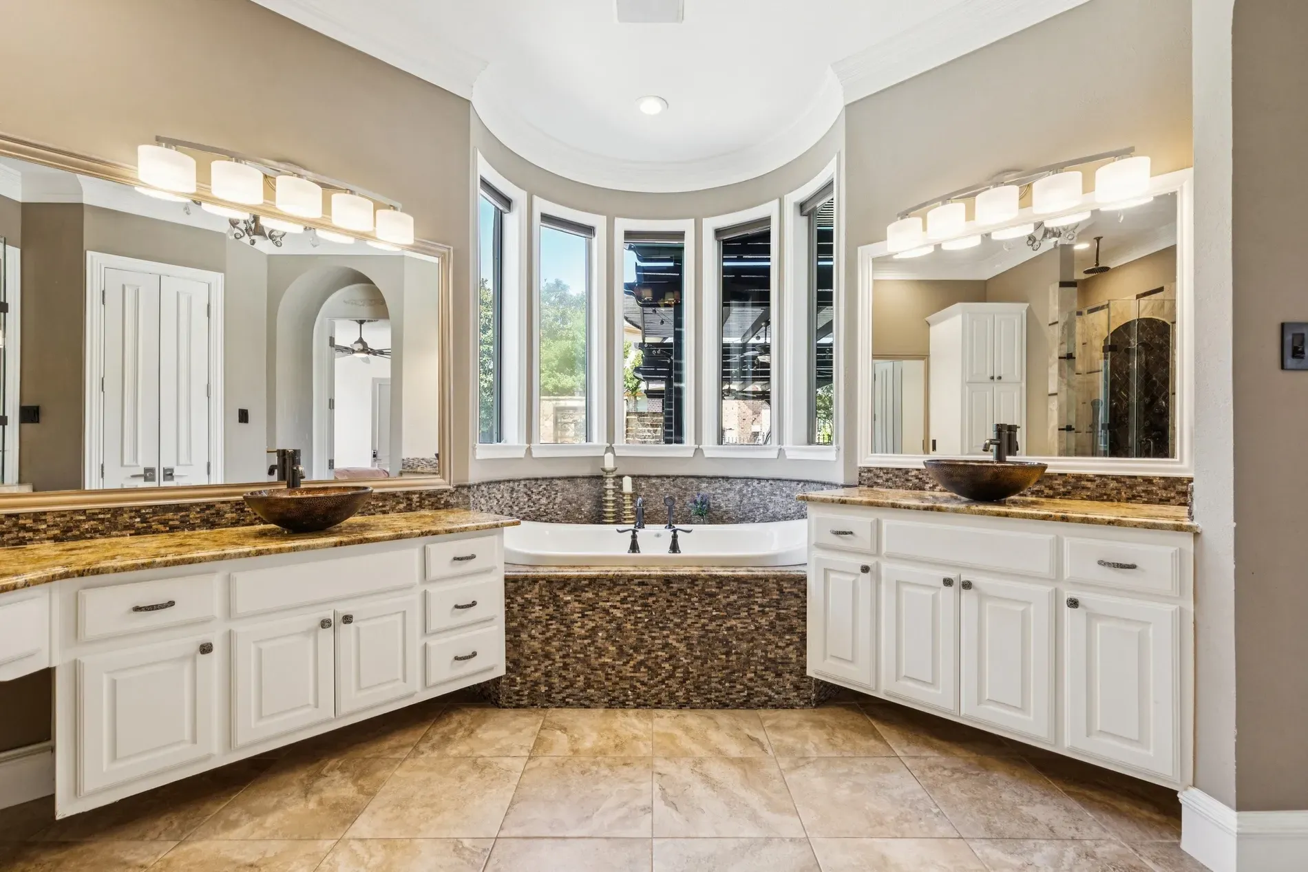 Here's the main bath — warm beige, granite, and that stone accent. Spa-ish.