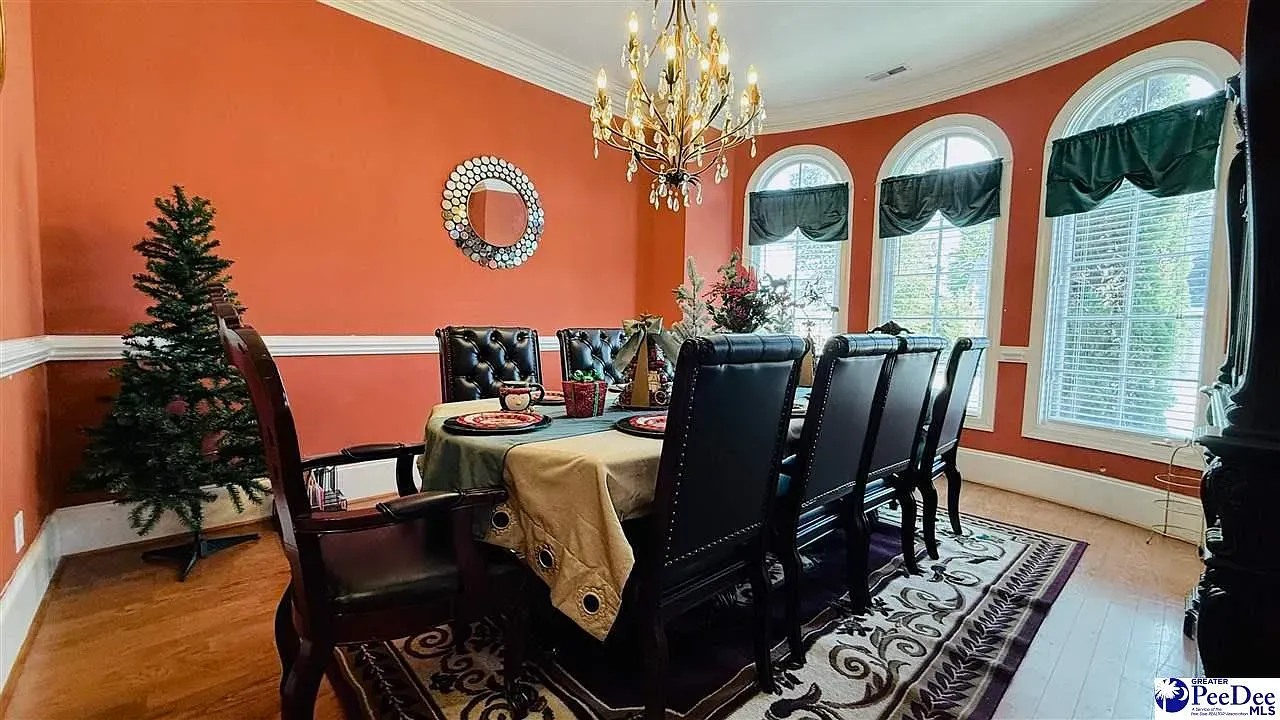 Terracotta dining room with a white chair rail. Cozy and classic.