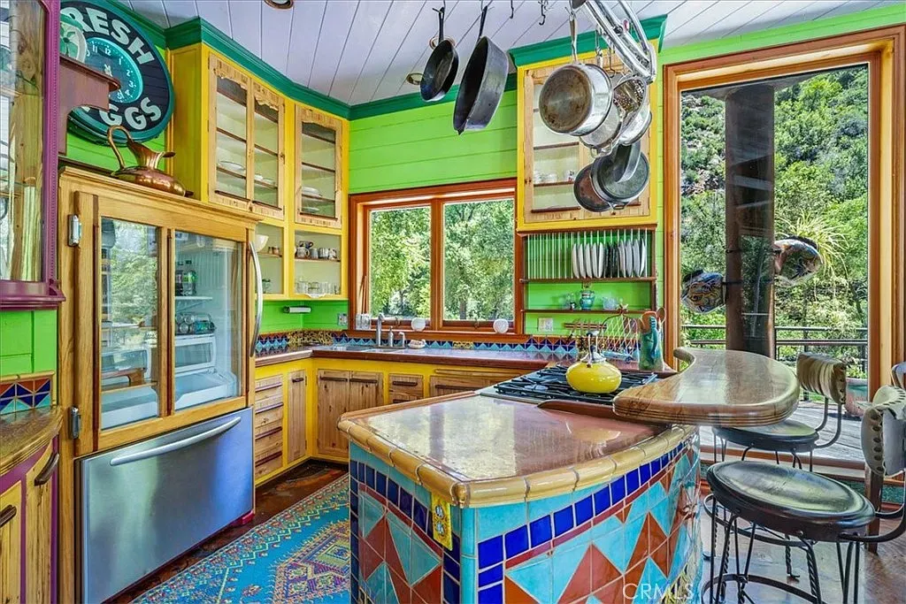 Green kitchen walls with rich wood cabinets. It actually works.