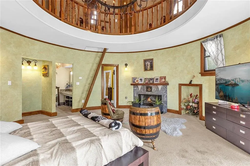 Round bedroom! Soft green walls and that circular ceiling detail is wild.